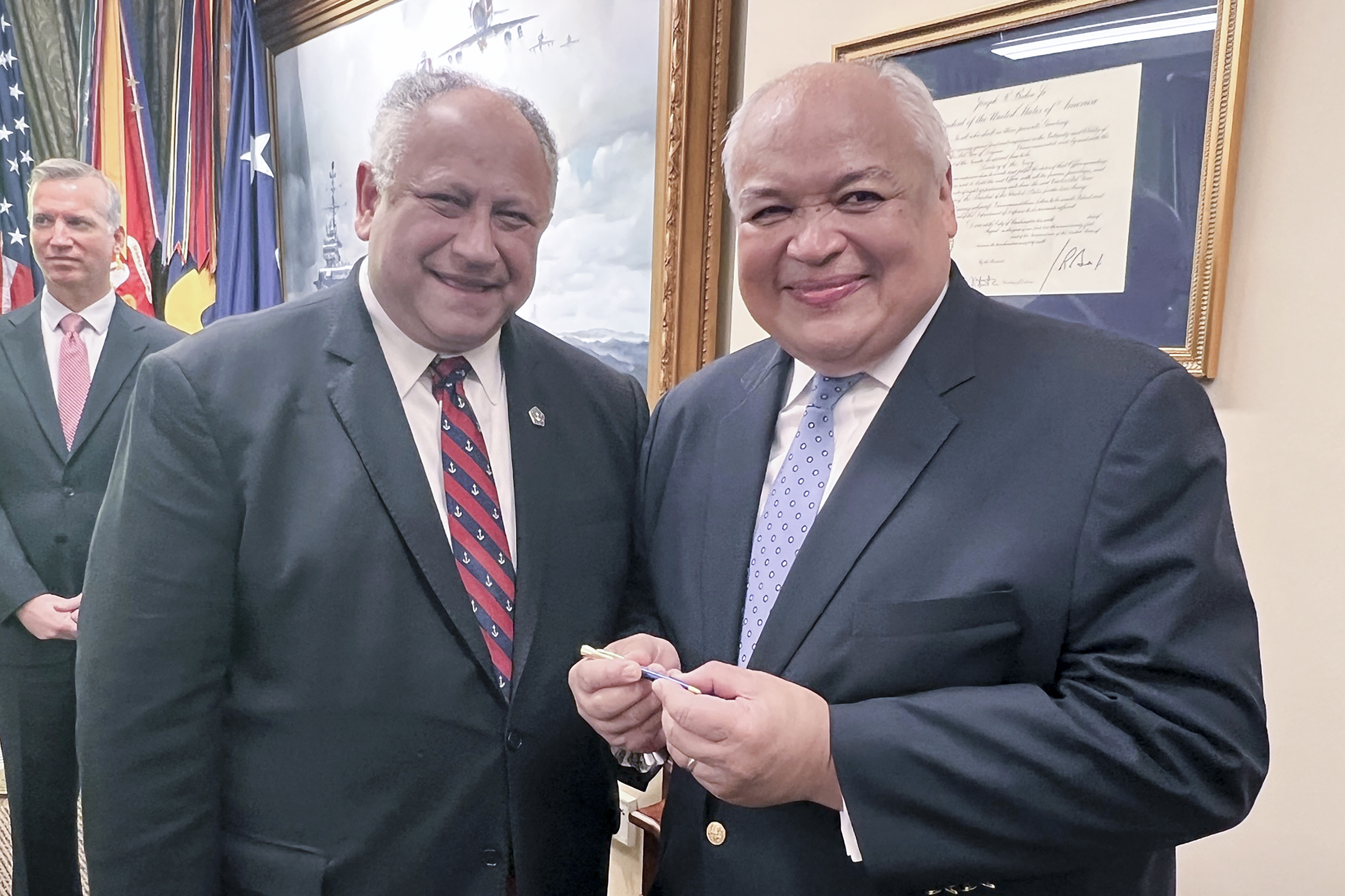 Thurgood Marshall, Jr. (right) smiles as he receives the first pen from Navy Secretary Carlos Del Toro (left), Wednesday, July 17, 2024 at the Pentagon in Washington, after it was used to sign documents exonerating 256 Black sailors who were unjustly court martialed in 1944 after the horrific Port Chicago explosion in California.<br />(Tara Copp / AP Photo)