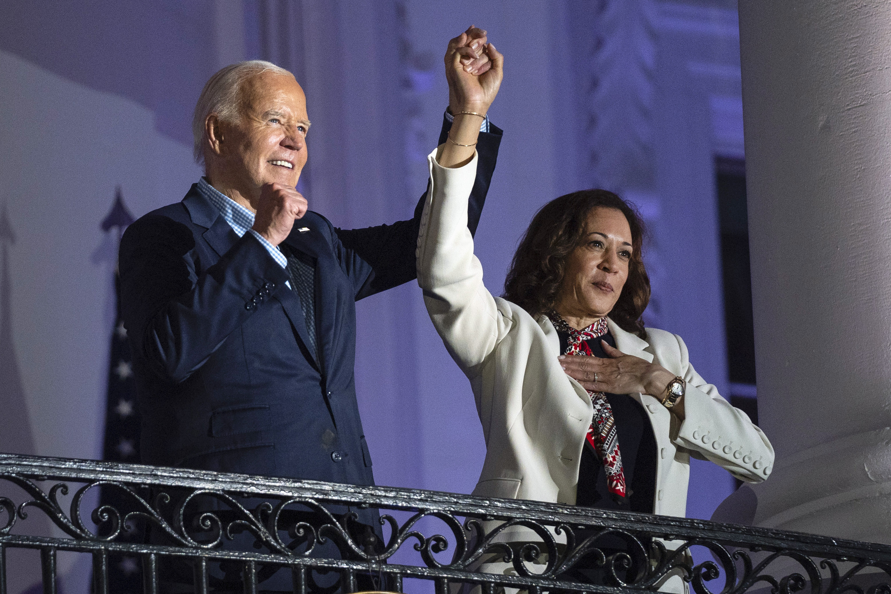 President Joe Biden raises the hand of Vice President Kamala Harris after viewing the Independence Day fireworks display over the National Mall from the balcony of the White House, Thursday, July 4, 2024, in Washington. The 59-year-old Harris was endorsed by Biden on Sunday, July 21, after he stepped aside amid widespread concerns about the viability of his candidacy.<br />(Evan Vucci / AP Photo)