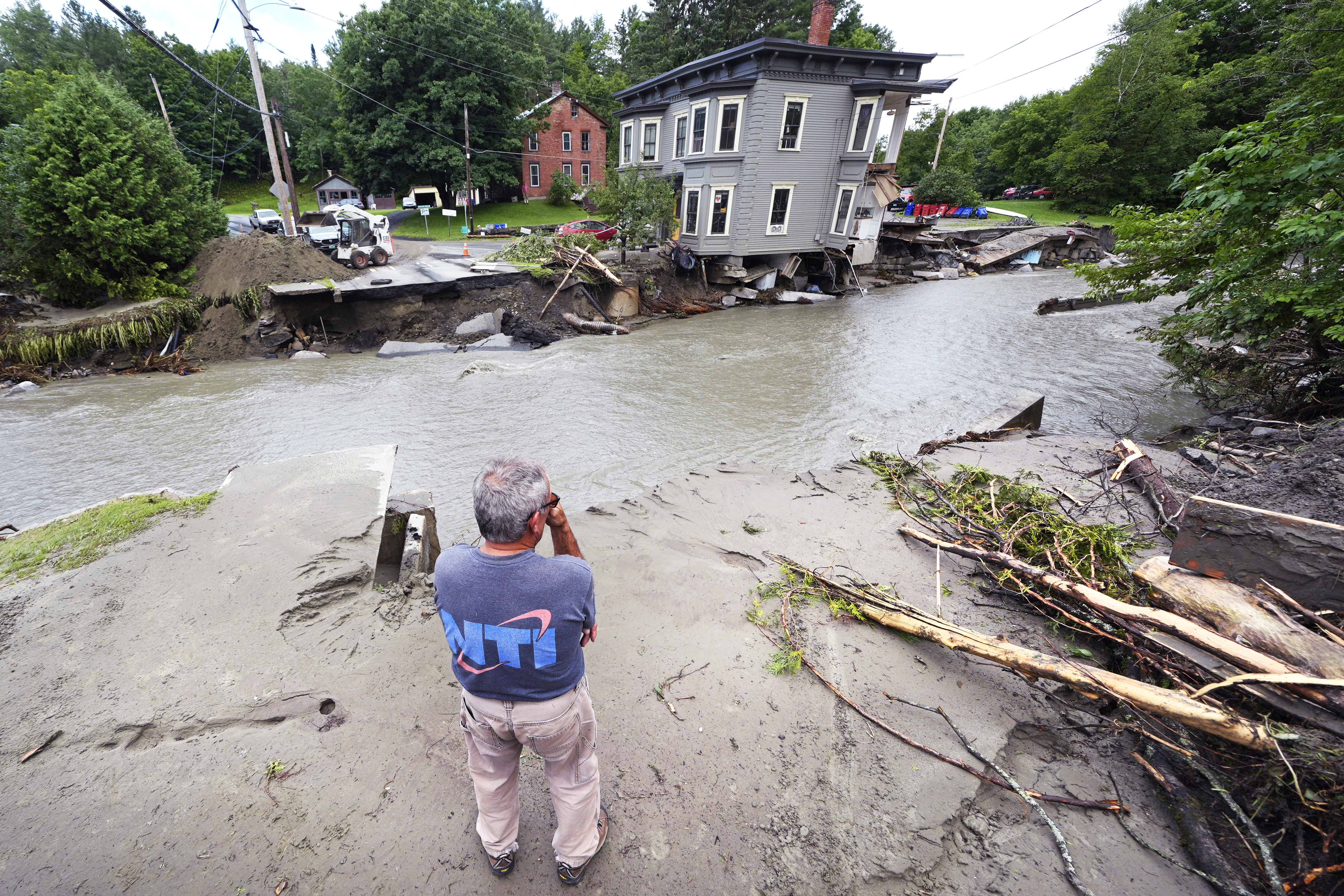 Rick Gordon, of Plainfield, Vt., looks at what remains of Mill Street and an apartment building after remnants of Hurricane Beryl caused flooding and destruction, Friday, July 12, 2024, in Plainfield.<br />(Charles Krupa / AP Photo)