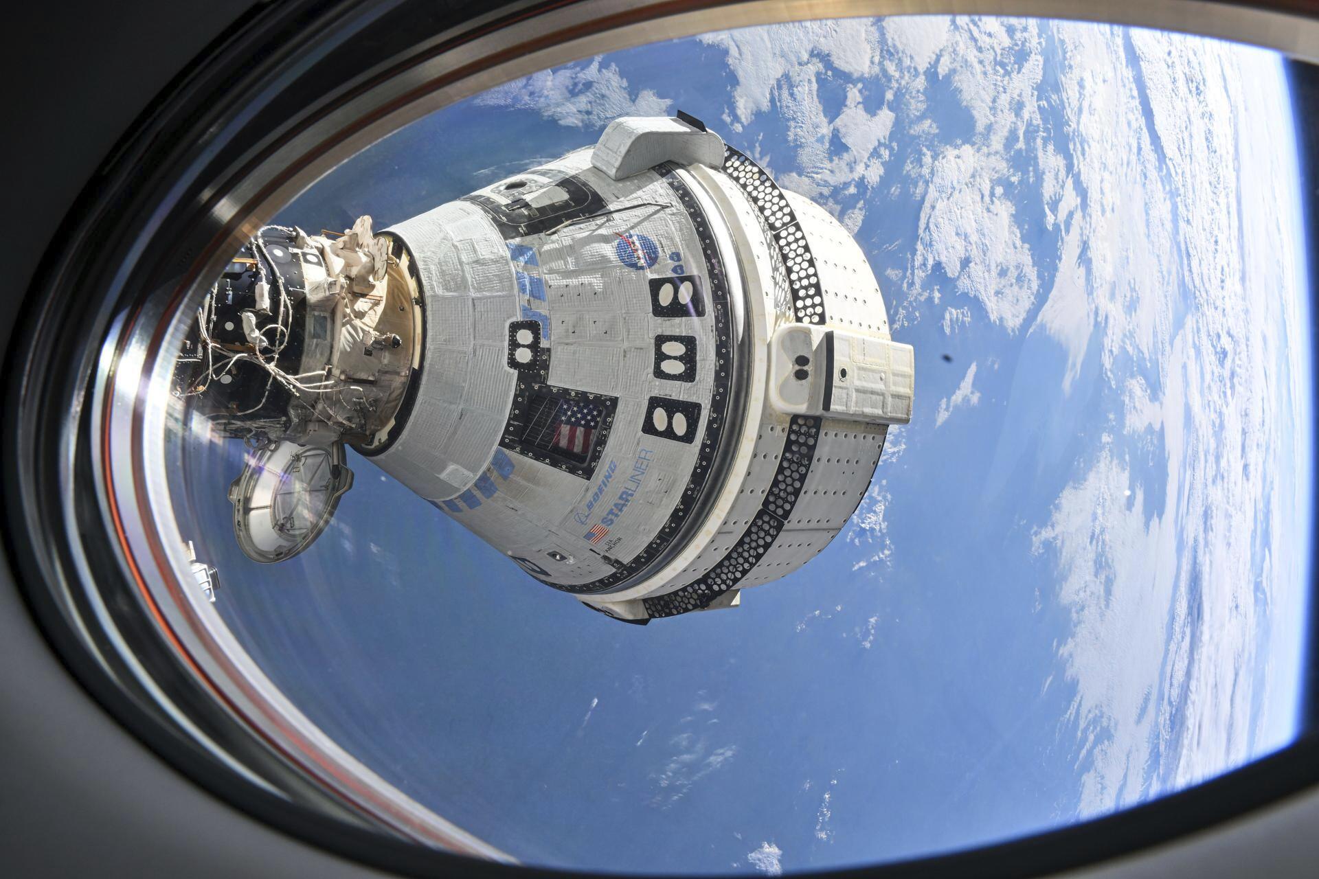 This photo provided by NASA shows Boeing&#039;s Starliner spacecraft which launched astronauts Butch Wilmore and Suni Williams to the International Space Station docked to the Harmony module&#039;s forward port on July 3, 2024, seen from a window on the SpaceX Dragon Endeavour spacecraft docked to the adjacent port.<br />(NASA via AP)