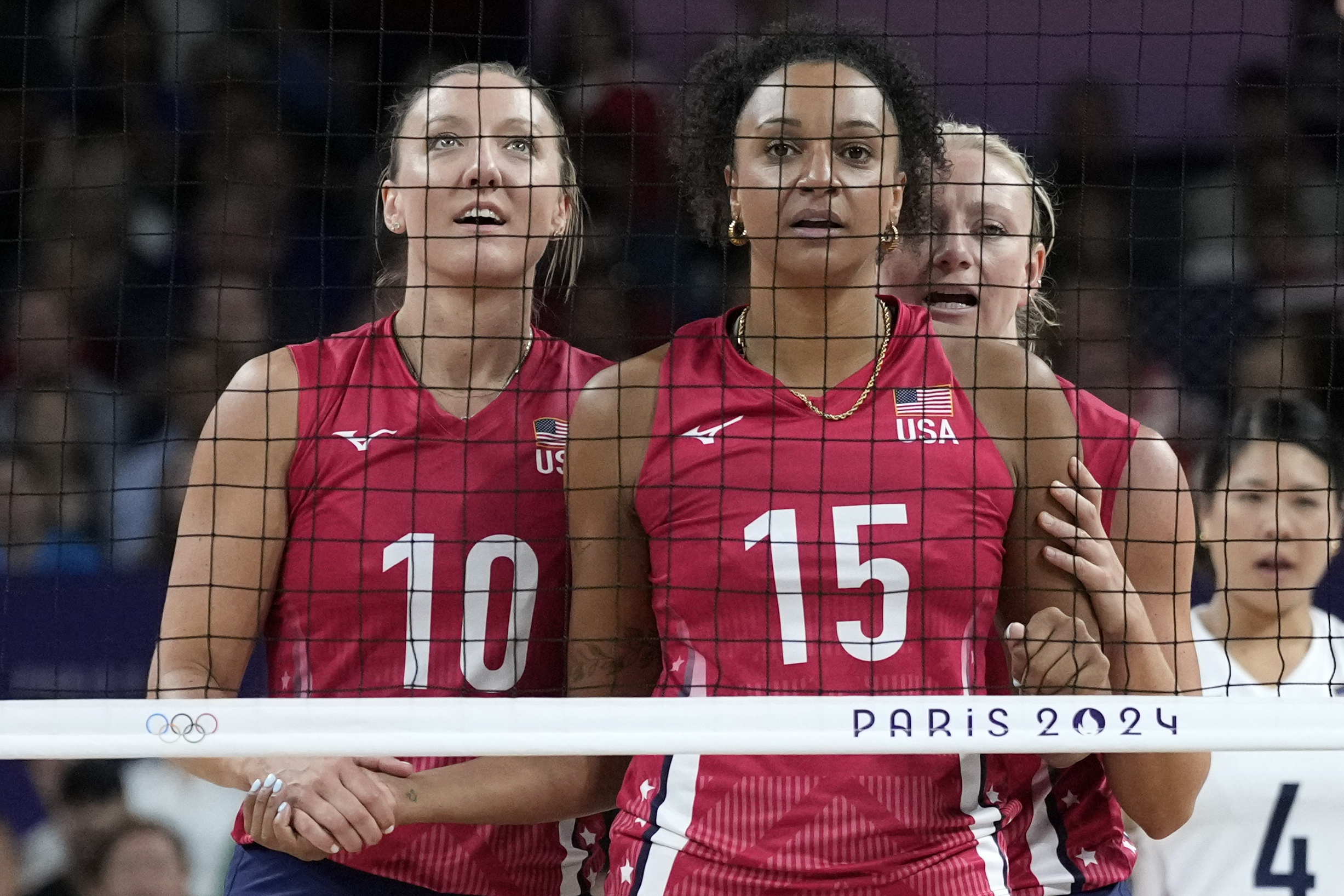 Jordan Larson (left) of the United States, and Haleigh Washington (center) of the United States, reacts behind the net during a gold medal women&#039;s volleyball match between the United States of America and Italy at the 2024 Summer Olympics, Sunday, Aug. 11, 2024, in Paris, France.<br /> (Alessandra Tarantino / AP Photo)