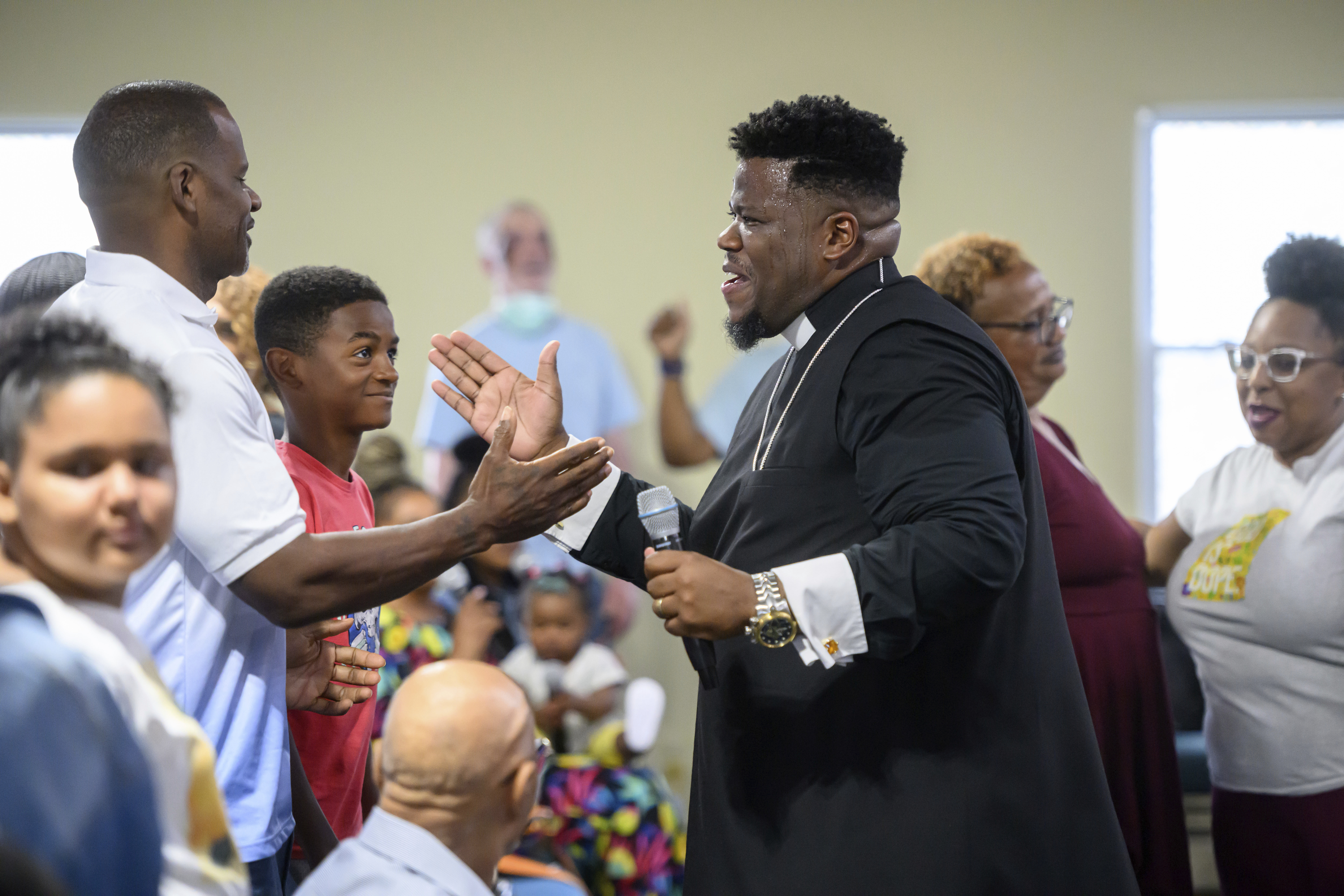 Pastor Rashad Singletary (center) greets parishioners during a service at Mt. Olive Baptist Church, Sunday, Aug. 18, 2024, in Turner Station, Md. Turner Station is located near the former site of the Francis Scott Key Bridge, which collapsed in March.<br />(Steve Ruark / AP Photo)