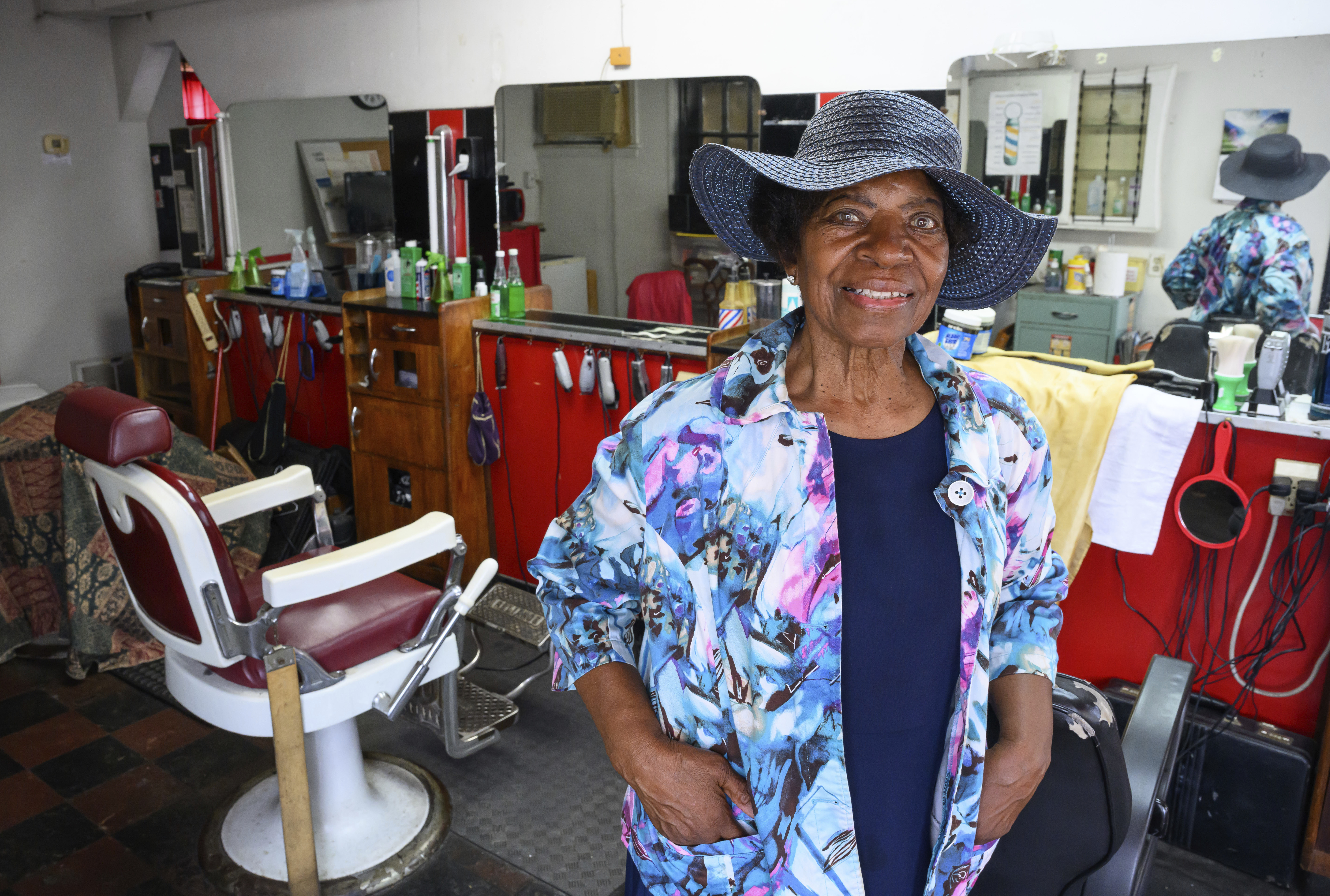 Courtney Speed, of Turner Station, Md., stands in Speed&#039;s Barber and Beauty, her salon, Sunday, Aug. 18, 2024, in Turner Station. Turner Station is located near the former site of the Francis Scott Key Bridge, which collapsed in March.<br />(Steve Ruark / AP Photo)