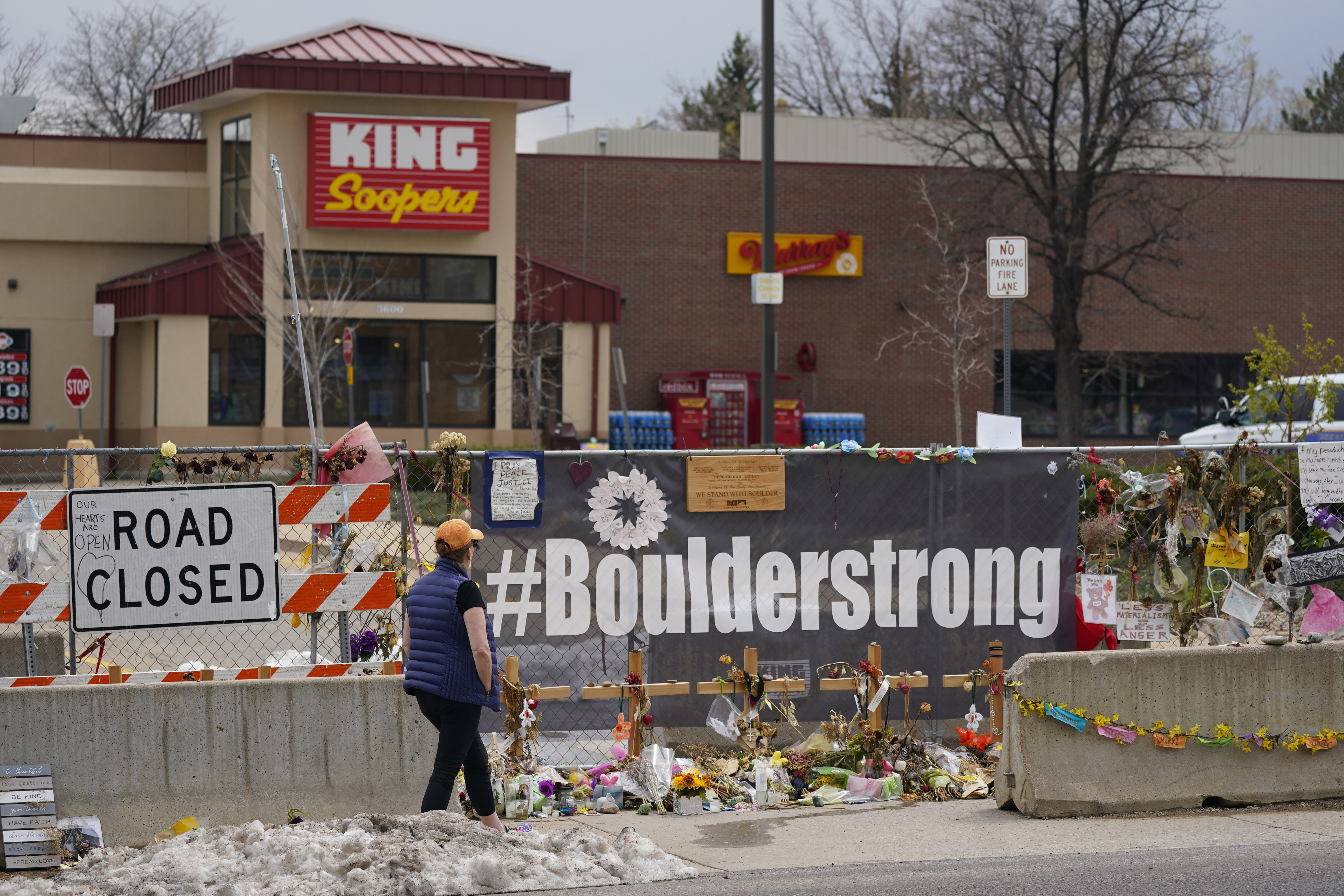 Tributes cover the temporary fence around the King Soopers grocery store in which 10 people died in a mass shooting on April 23, 2021, in Boulder, Colorado.<br />(David Zalubowski / AP Photo)