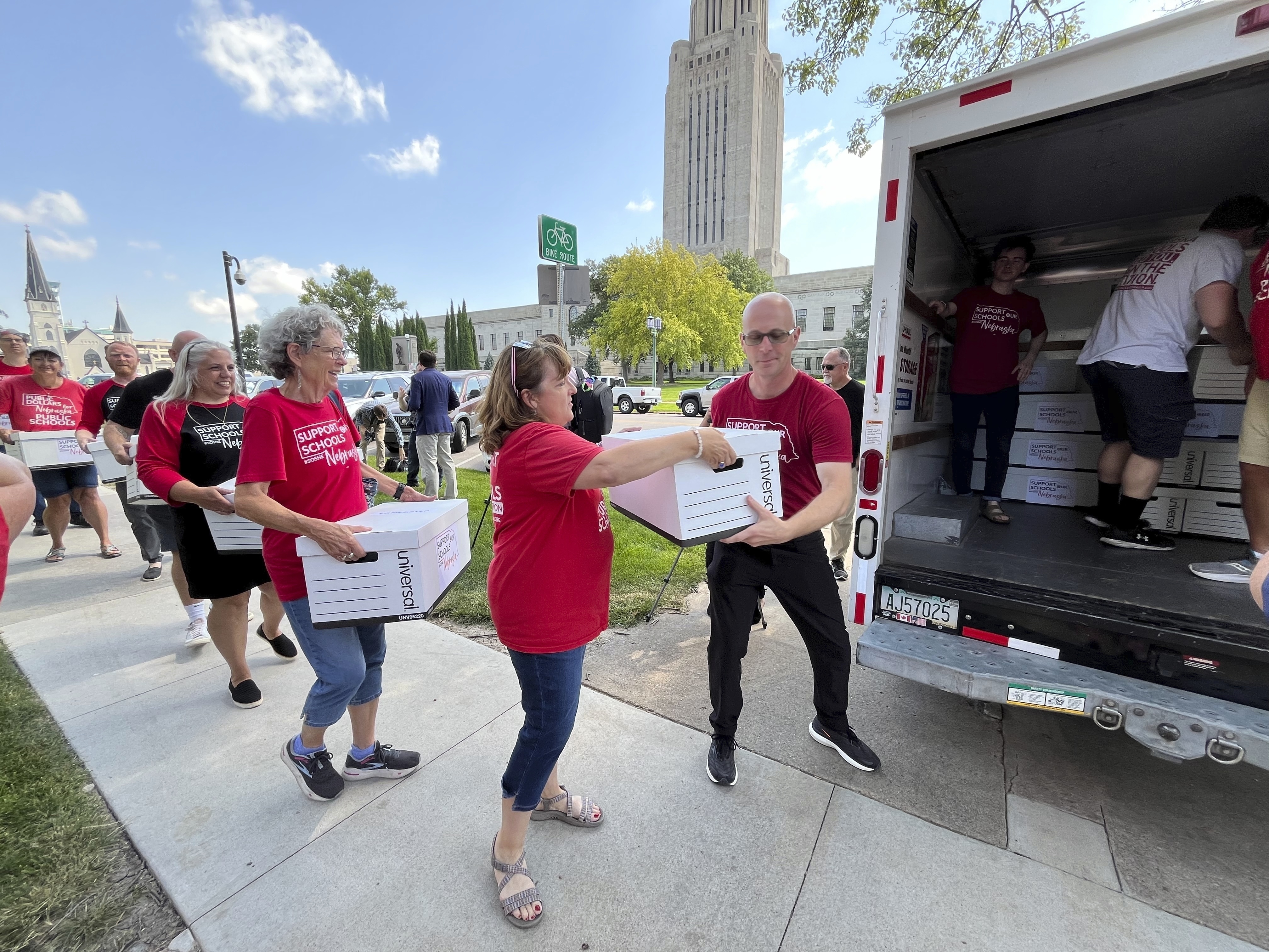 Organizers load boxes of signed petitions seeking to get a measure on the November ballot that would repeal a new Nebraska law providing taxpayer money for private school tuition, July 17, 2024, in Lincoln, Neb.<br />(Margery Beck / AP Photo)