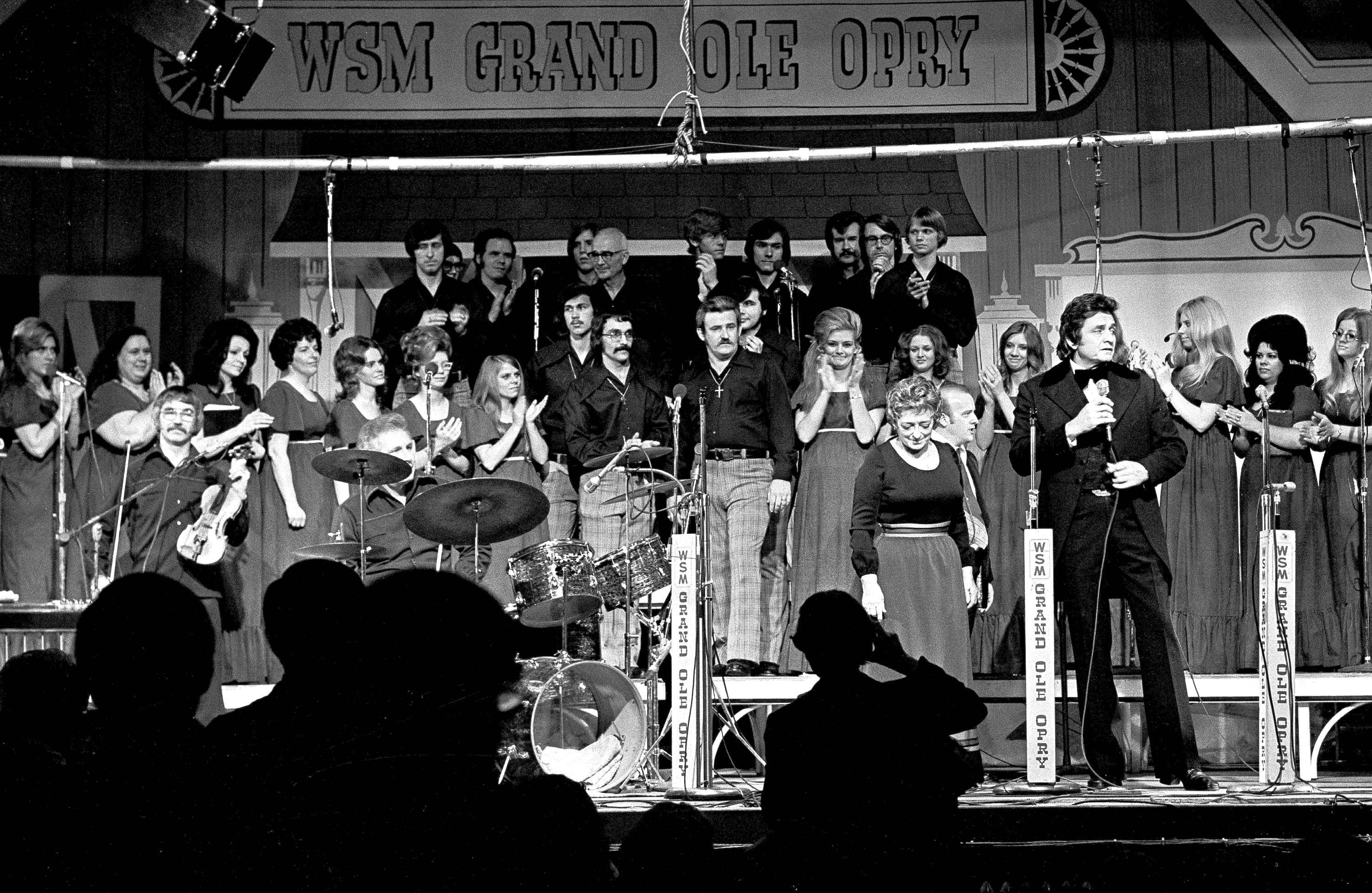 Country music stars, including Johnny Cash (foreground right) and Maybelle Carter (next to Cash) perform during the Grand Ole Opry&#039;s last show at Ryman Auditorium in Nashville, Tenn., March 18, 1974.<br />(John Duricka / AP Photo)