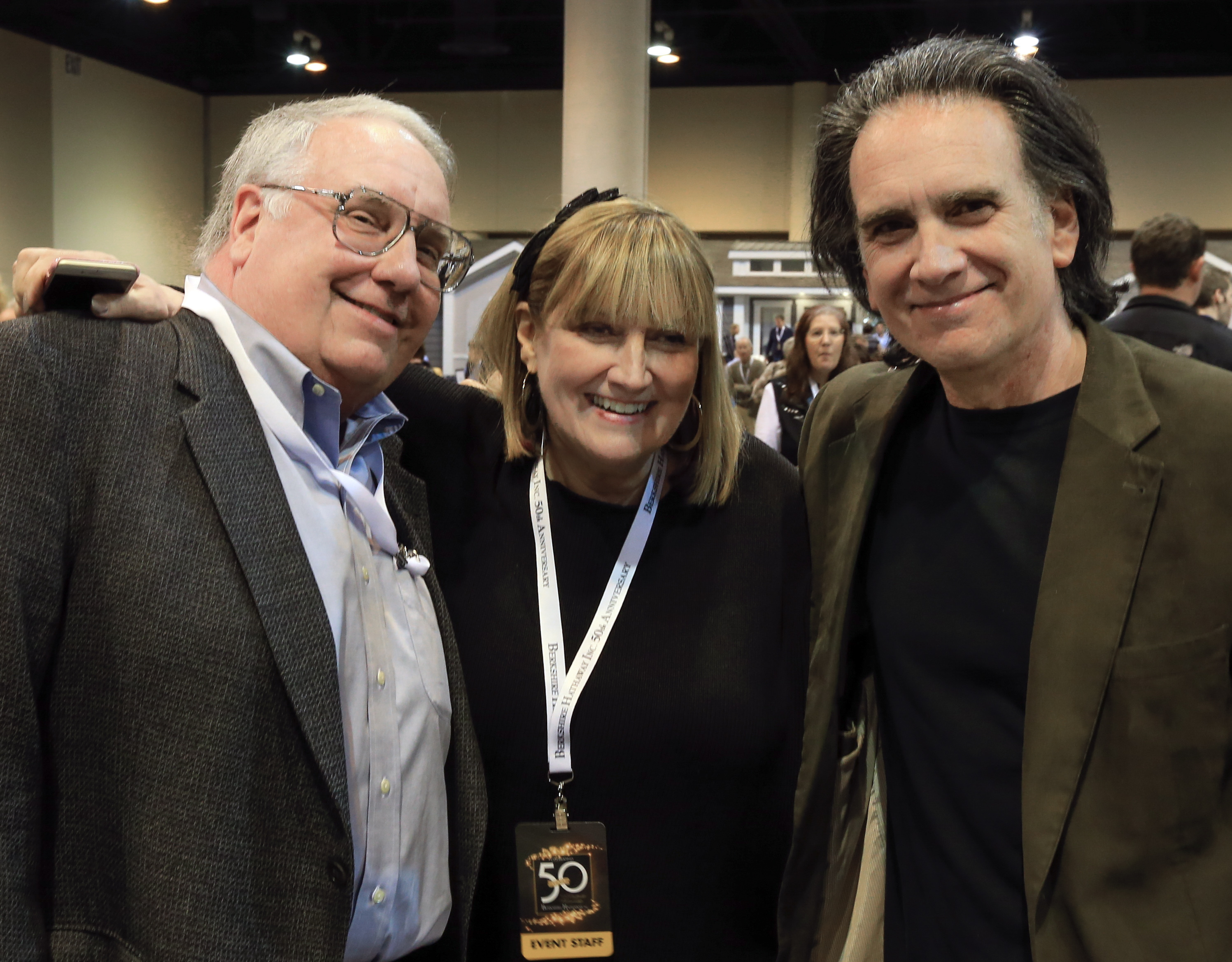 The children of Berkshire Hathaway Chairman and CEO Warren Buffett (from left) Howard Buffett, Susie Buffett, and Peter Buffett, pose for a photo at the CenturyLink Center exhibit hall in Omaha, Neb., May 1, 2015.<br />(Nati Harnik / AP Photo)