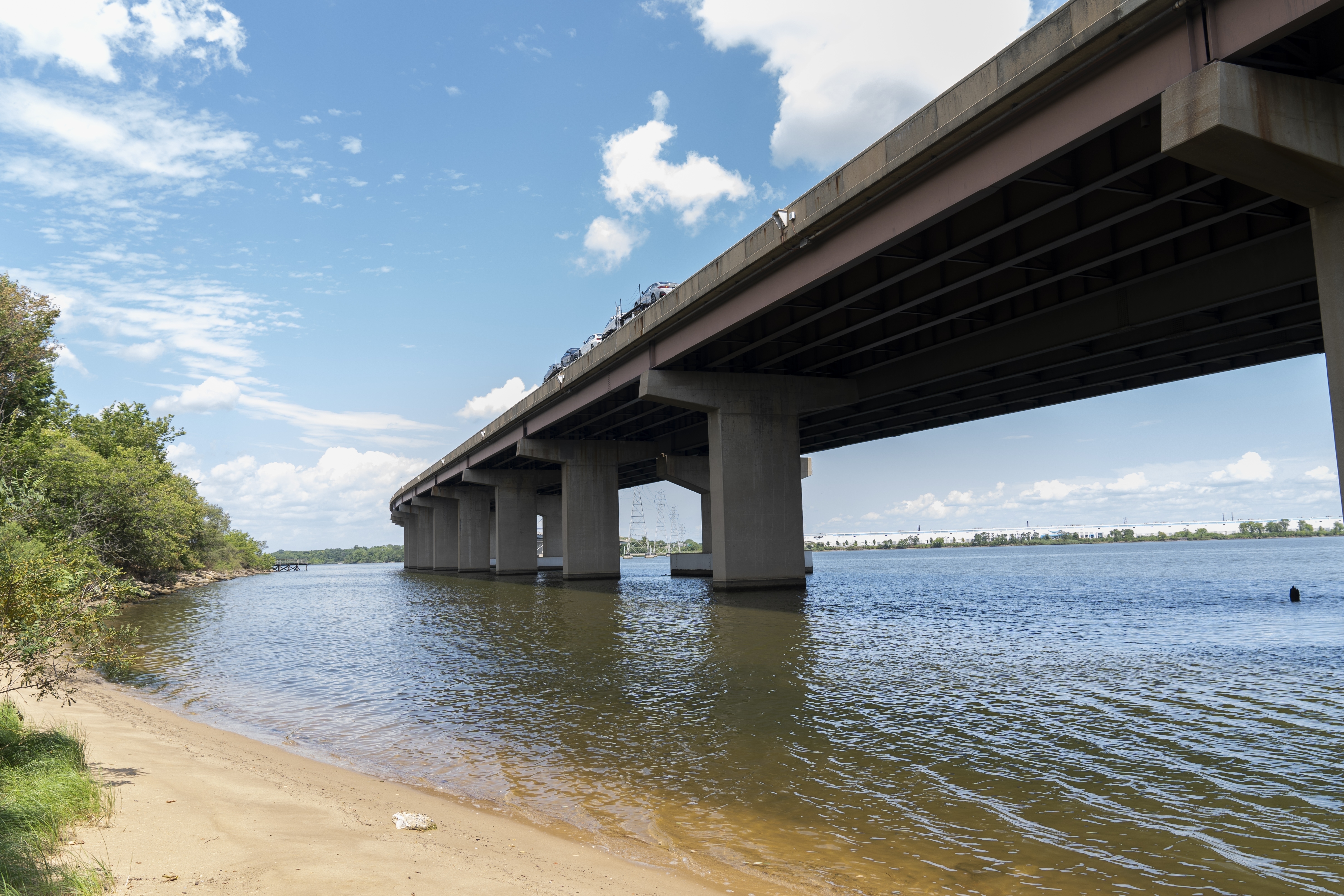 A small beach below the remaining portion of the Francis Scott Key Bridge is seen, Tuesday, Aug. 13, 2024, in Turner Station, Md. The water is unsafe for swimming and fishing from decades of industrial pollution.<br />(Stephanie Scarbrough / AP Photo)