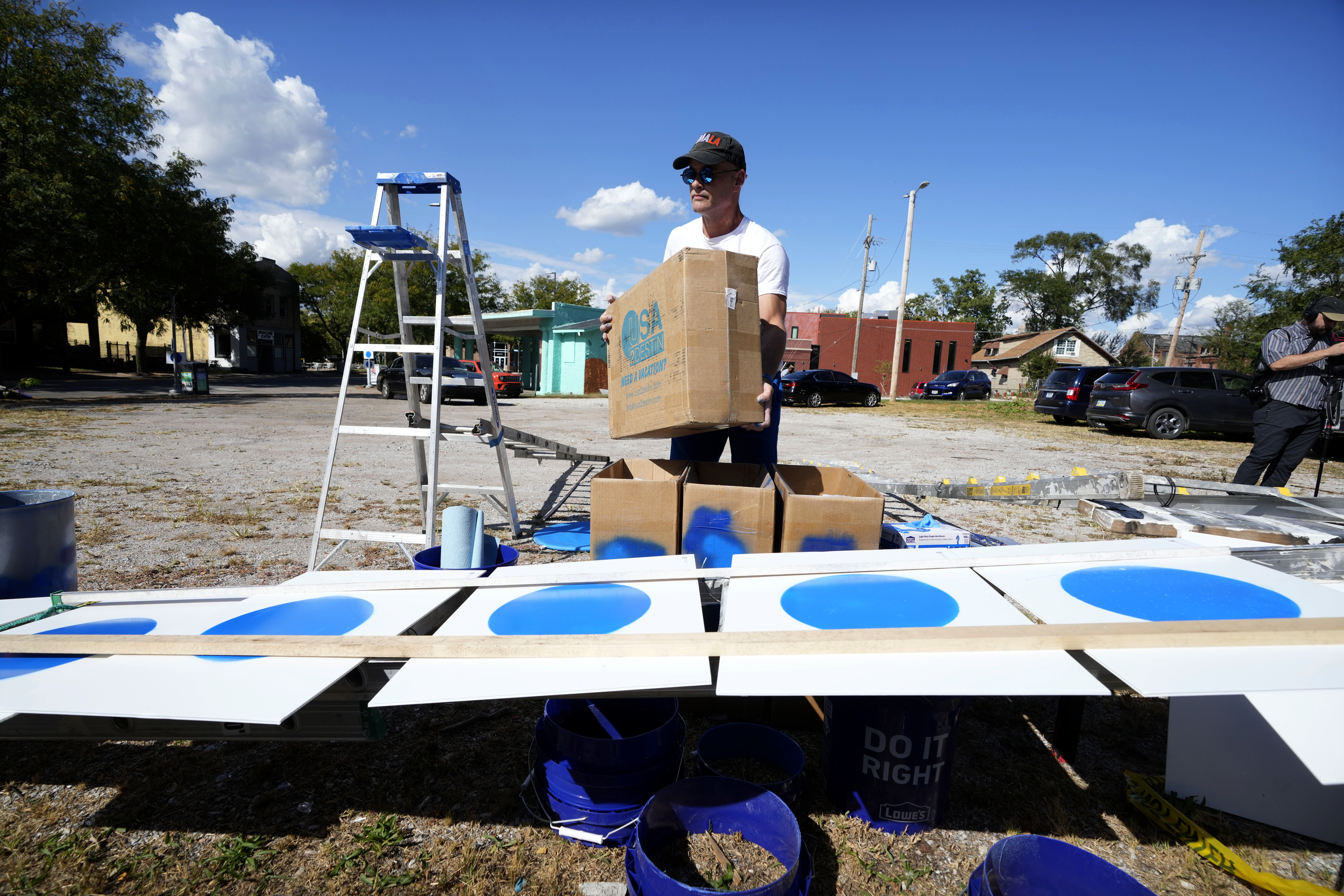 Jason Brown displays blue dot campaign signs, that represent Democratic-voting households in a state surrounded by Republican red, before a blue dot campaign sign get-together, Tuesday, Sept. 24, 2024, in Omaha, Neb.<br />(Charlie Neibergall / AP Photo)