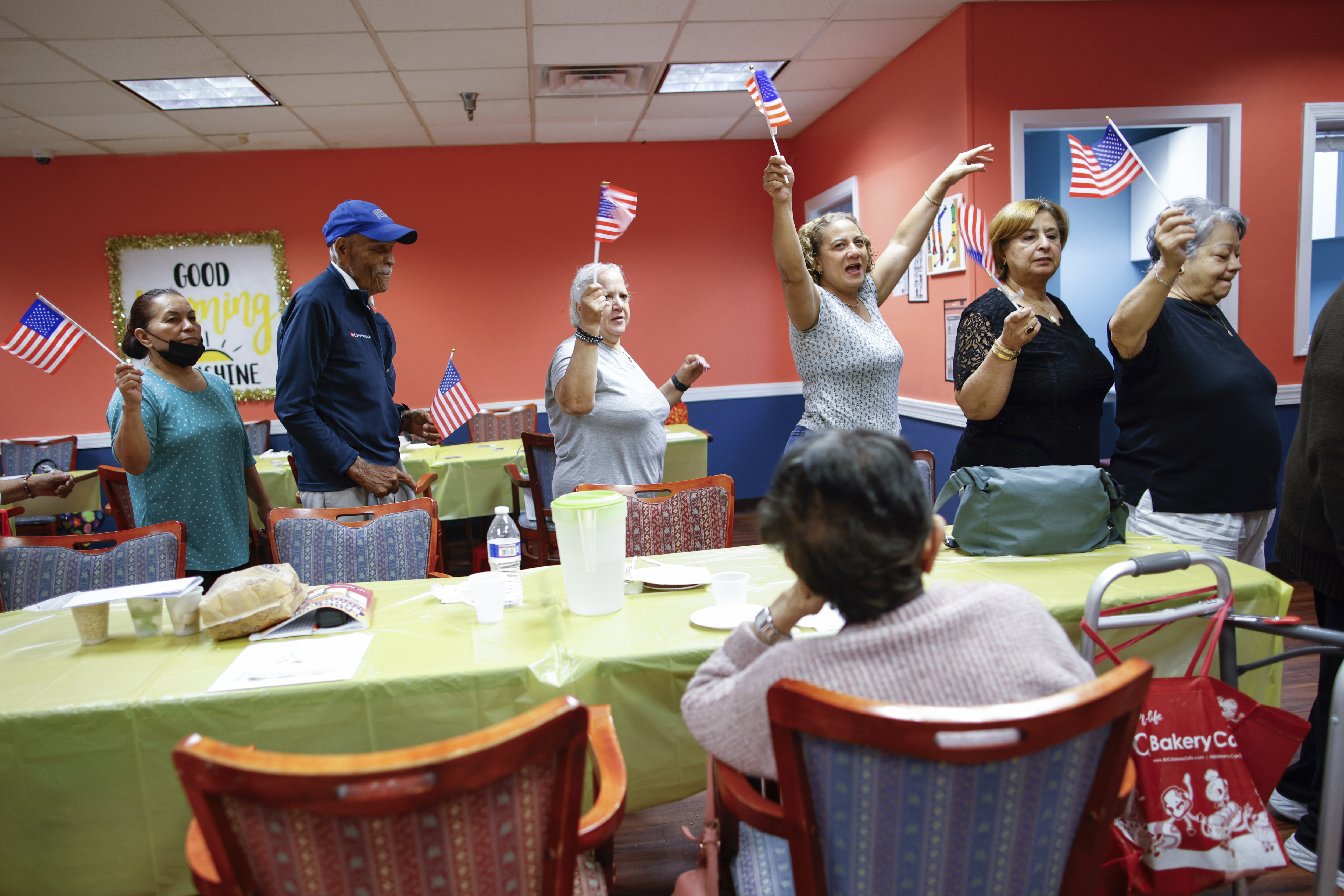 People march in a line as they take part in a multicultural parade at Sunshine Adult Day Center in Bergenfield, N.J., Monday, Aug. 26, 2024.<br />(Kena Betancur / AP Photo)