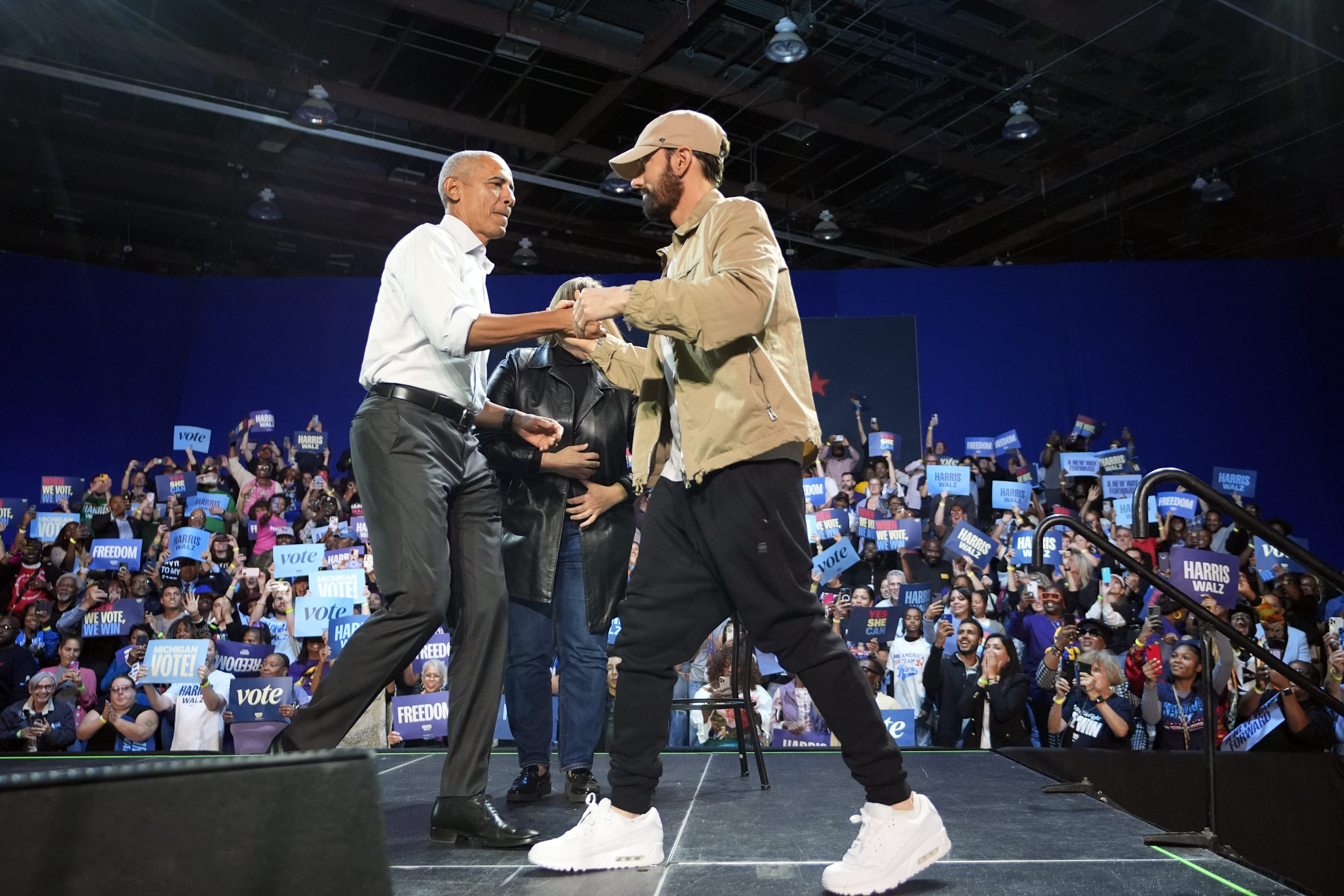 Rapper Eminem (right) greets former President Barack Obama (left) on stage at a campaign rally supporting Democratic presidential nominee Vice President Kamala Harris, Tuesday, Oct. 22, 2024, in Detroit.<br />(Paul Sancya / AP Photo)