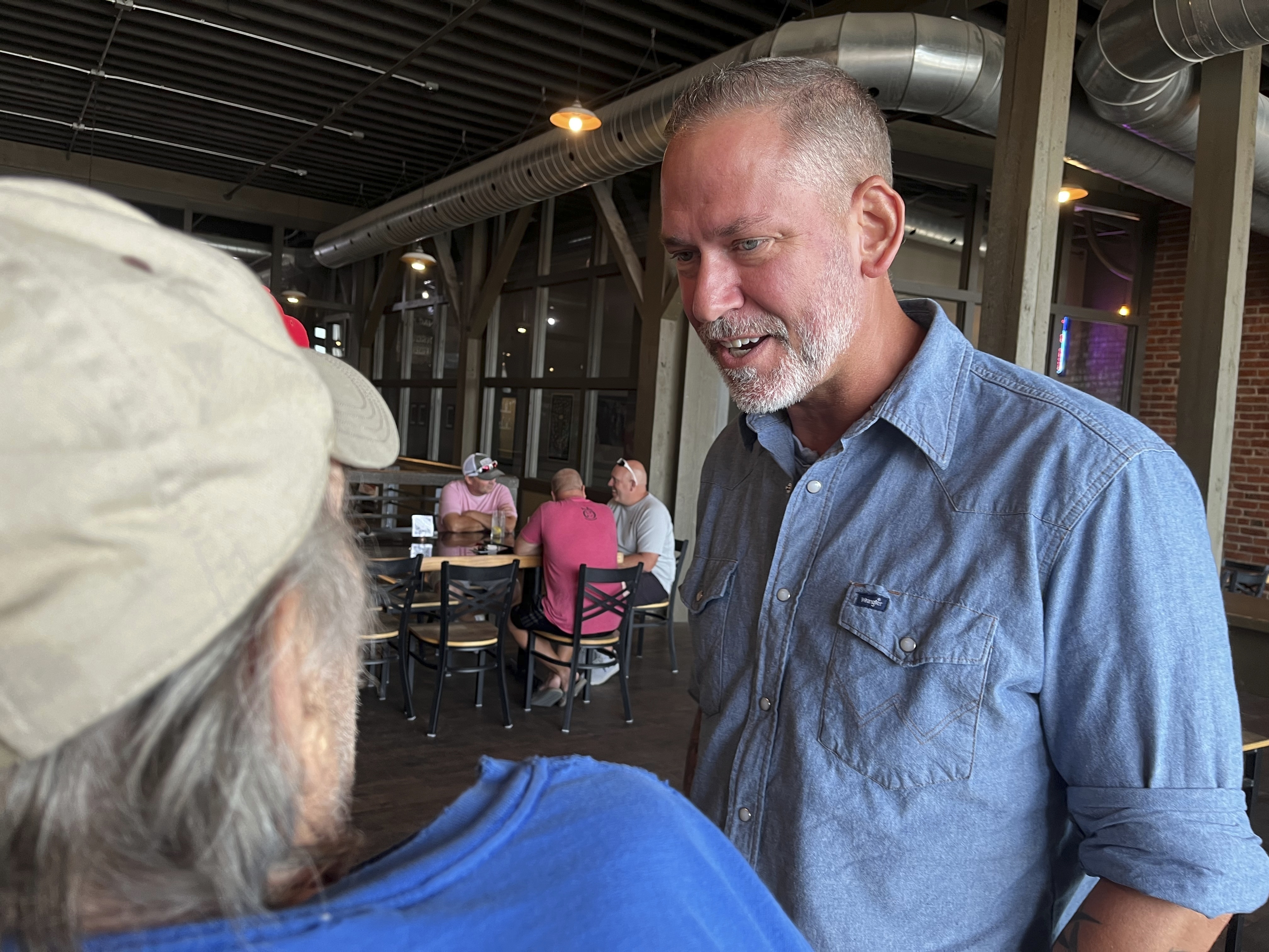 Independent Dan Osborn, a challenger to two-term Republican Sen. Deb Fischer, chats with patrons of a brewery in Beatrice, Neb., July 30, 2024.<br />(Margery Beck / AP Photo)