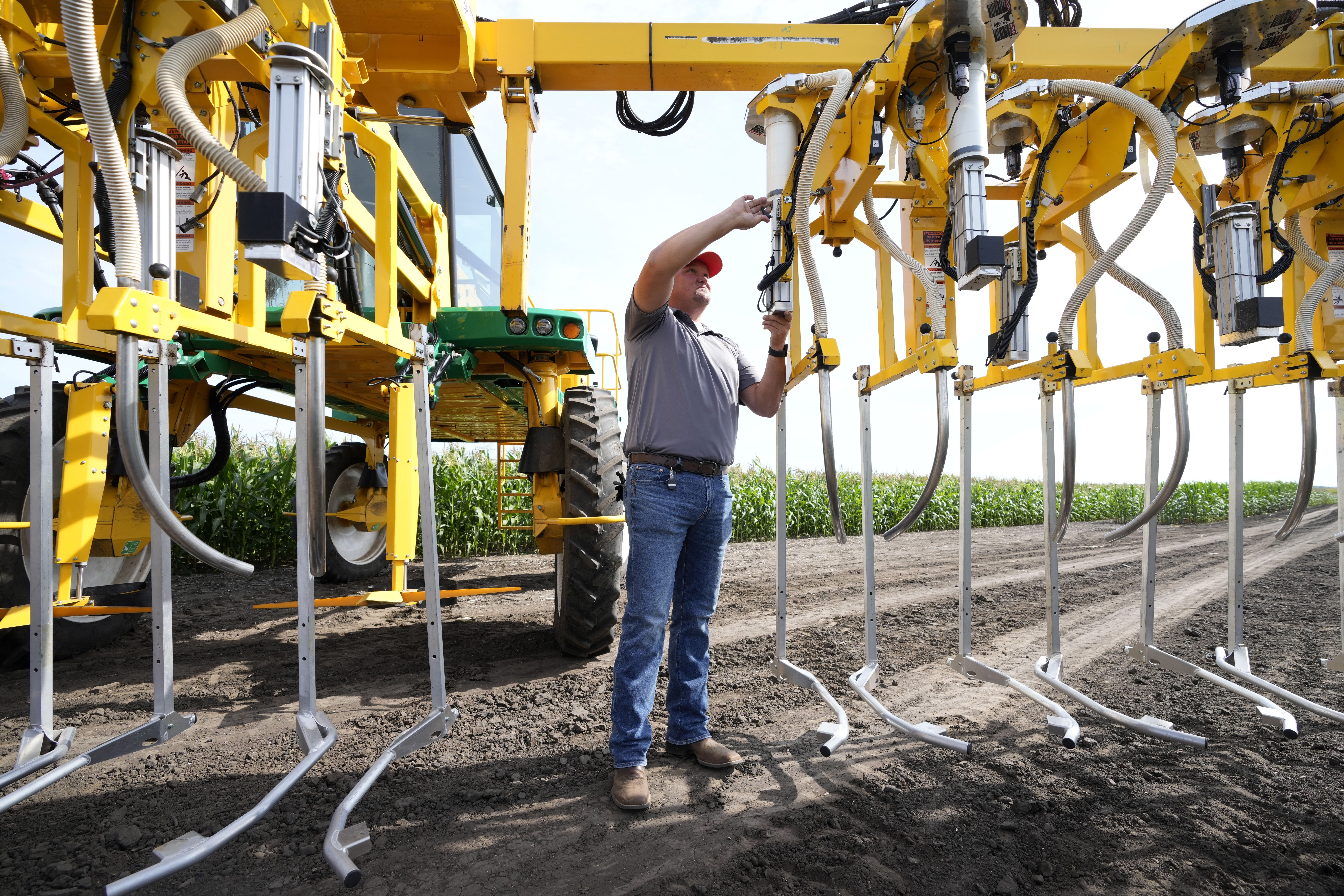 Jake Klocke, of PowerPollen, prepares a pollen applicator, Thursday, Aug. 22, 2024, near Ames, Iowa.<br />(Charlie Neibergall / AP Photo)