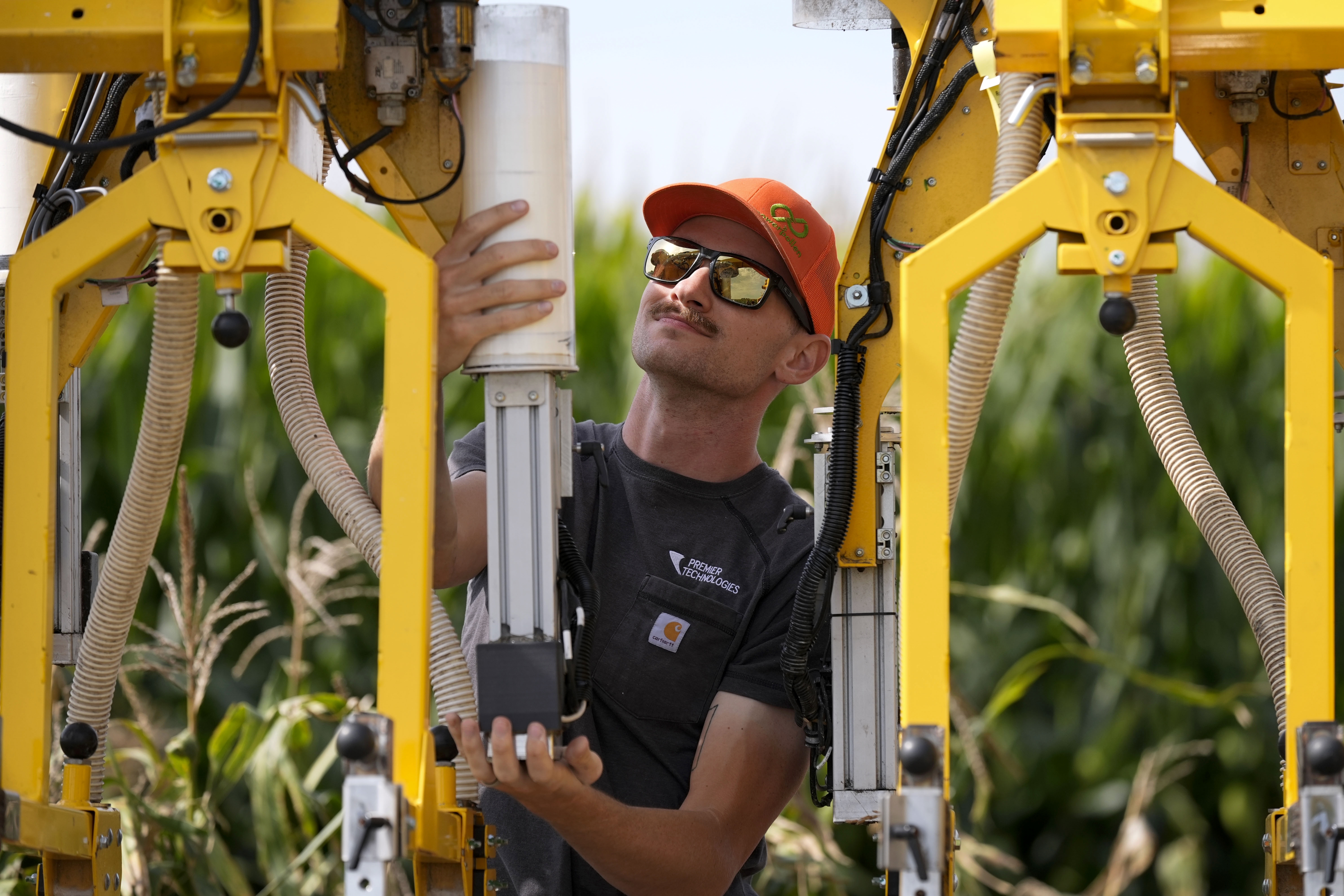 PowerPollen intern Evan Mark prepares a pollen applicator, Thursday, Aug. 22, 2024, near Ames, Iowa.<br />(Charlie Neibergall / AP Photo)