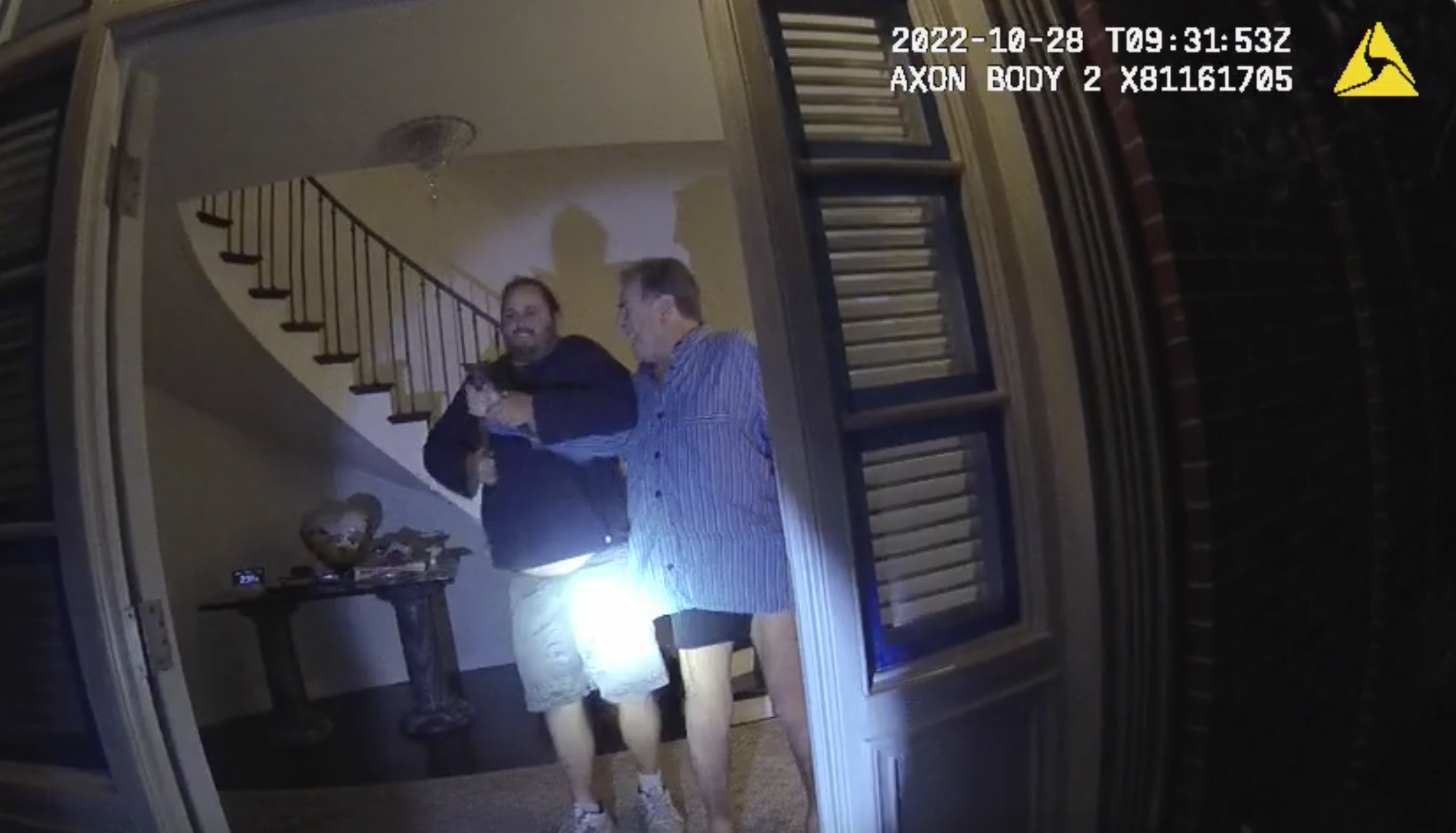 In this image taken from San Francisco Police Department body camera video, the husband of former U.S. House Speaker Nancy Pelosi, Paul Pelosi (right) fights for control of a hammer with his assailant, David DePape, during a brutal attack in the couple&#039;s San Francisco home on Oct. 28, 2022.<br />(San Francisco Police Department via AP)
