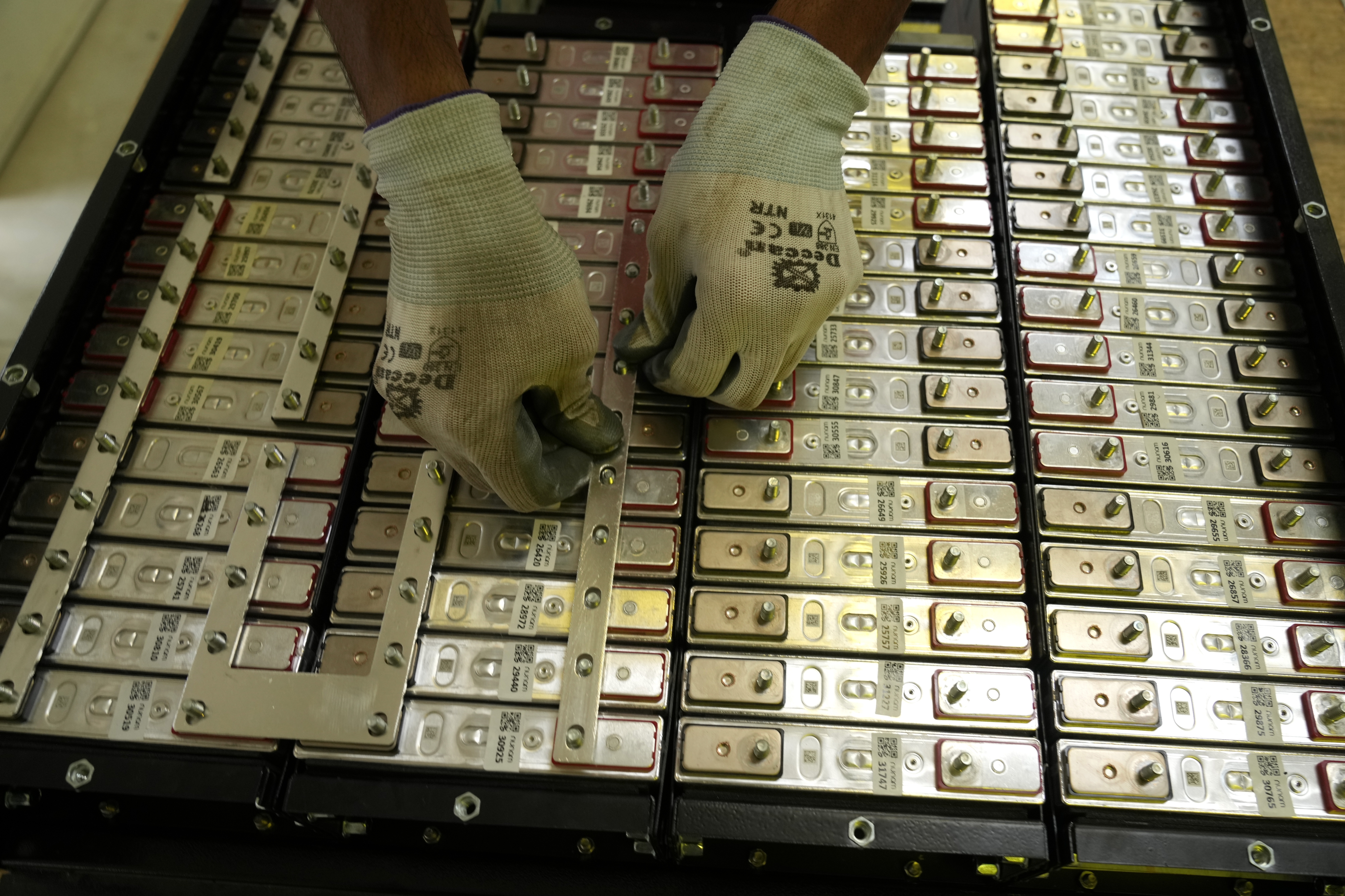 A battery production engineer at Nunam assembles a refurbished battery pack, made from used electric vehicle batteries, at their facility in Bengaluru, India, Tuesday, Oct. 8, 2024.<br />(Aijaz Rahi / AP Photo)