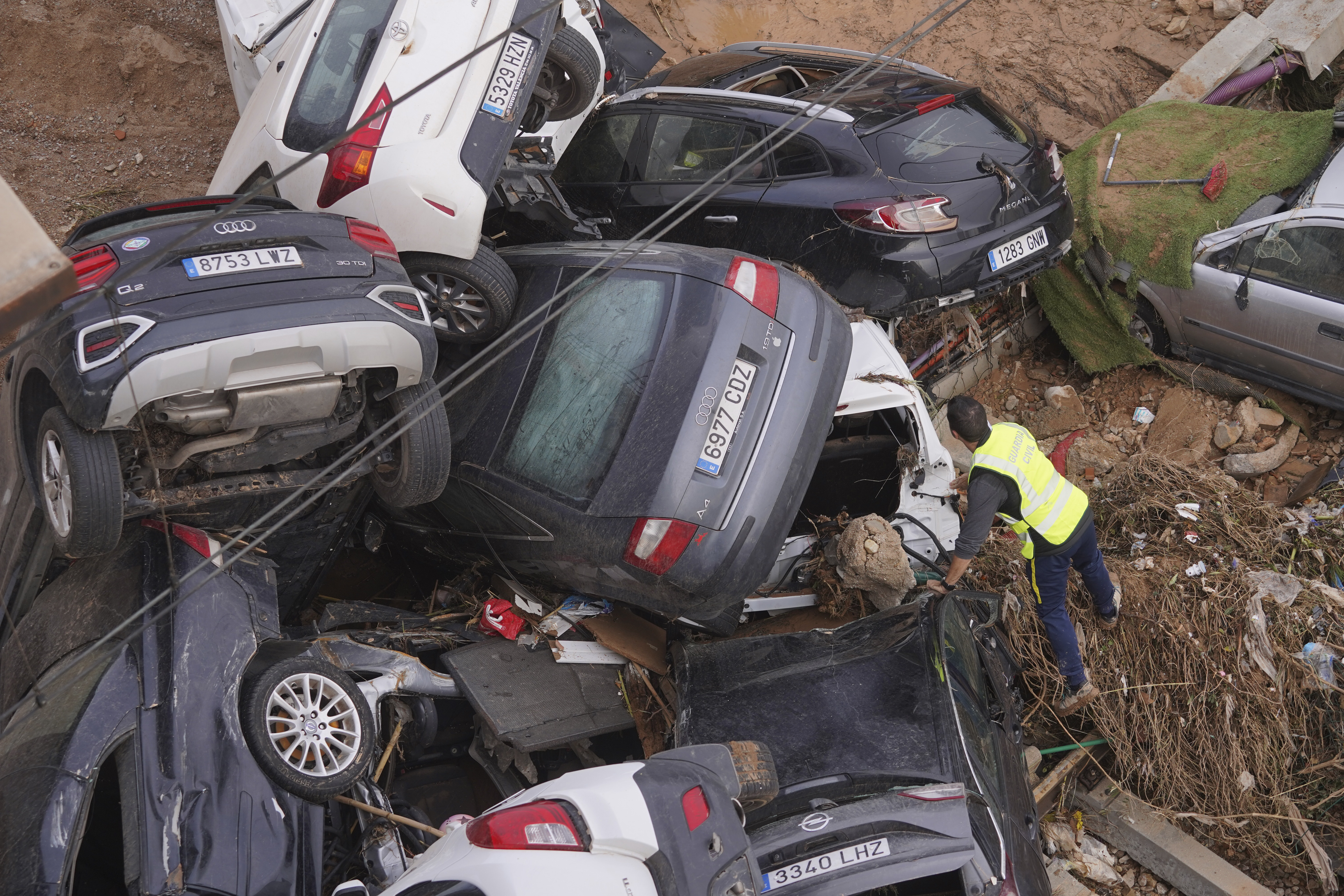 A civil guard searches for survivors in cars piled up on the outskirts of Valencia, Spain, Friday, Nov. 1, 2024 after flooding.<br />(Alberto Saiz / AP Photo)