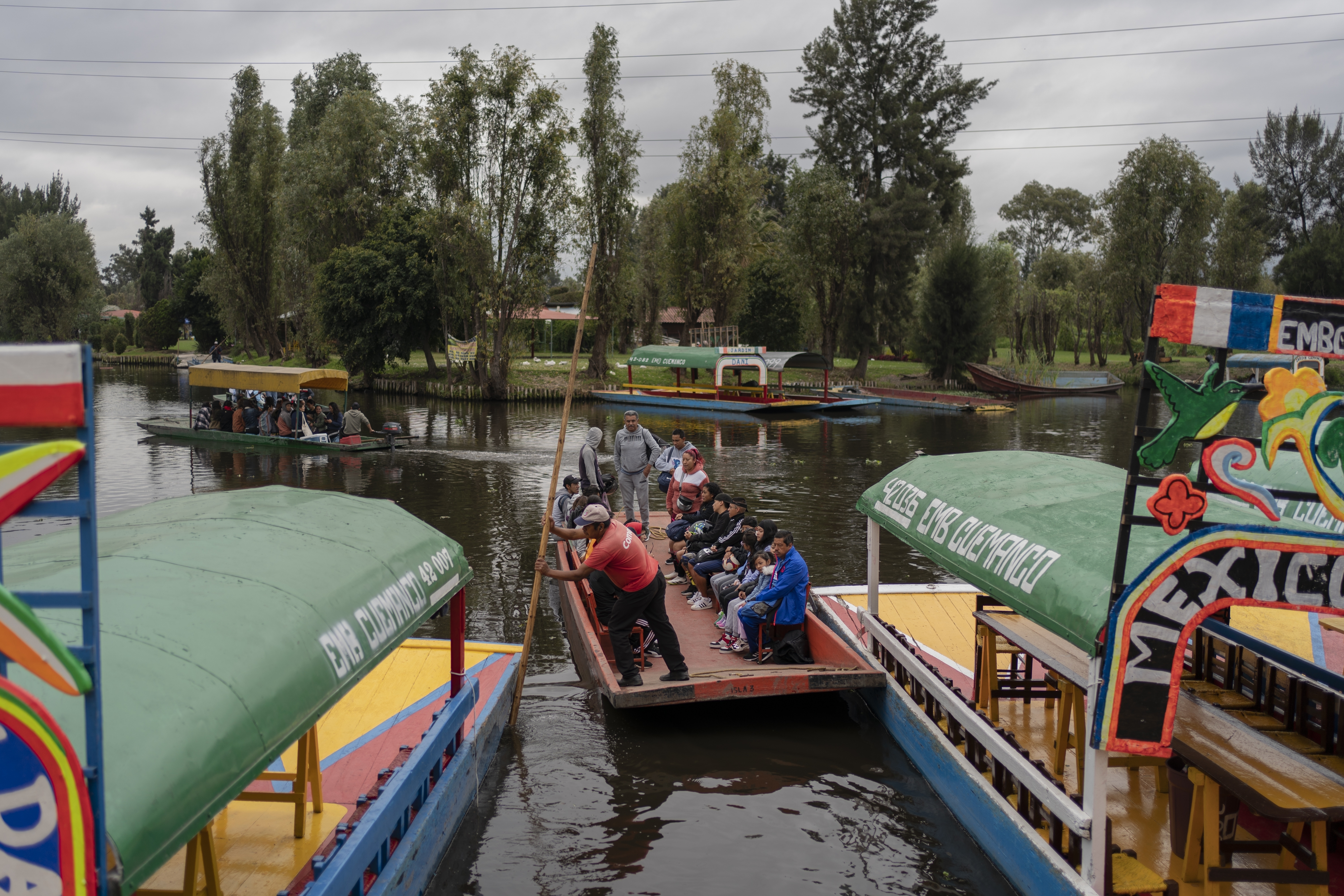 Amateur soccer players and families travel in a traditional canoe in the Xochimilco borough of Mexico City, on Sunday, October 20, 2024.<br />(Felix Marquez / AP Photo)