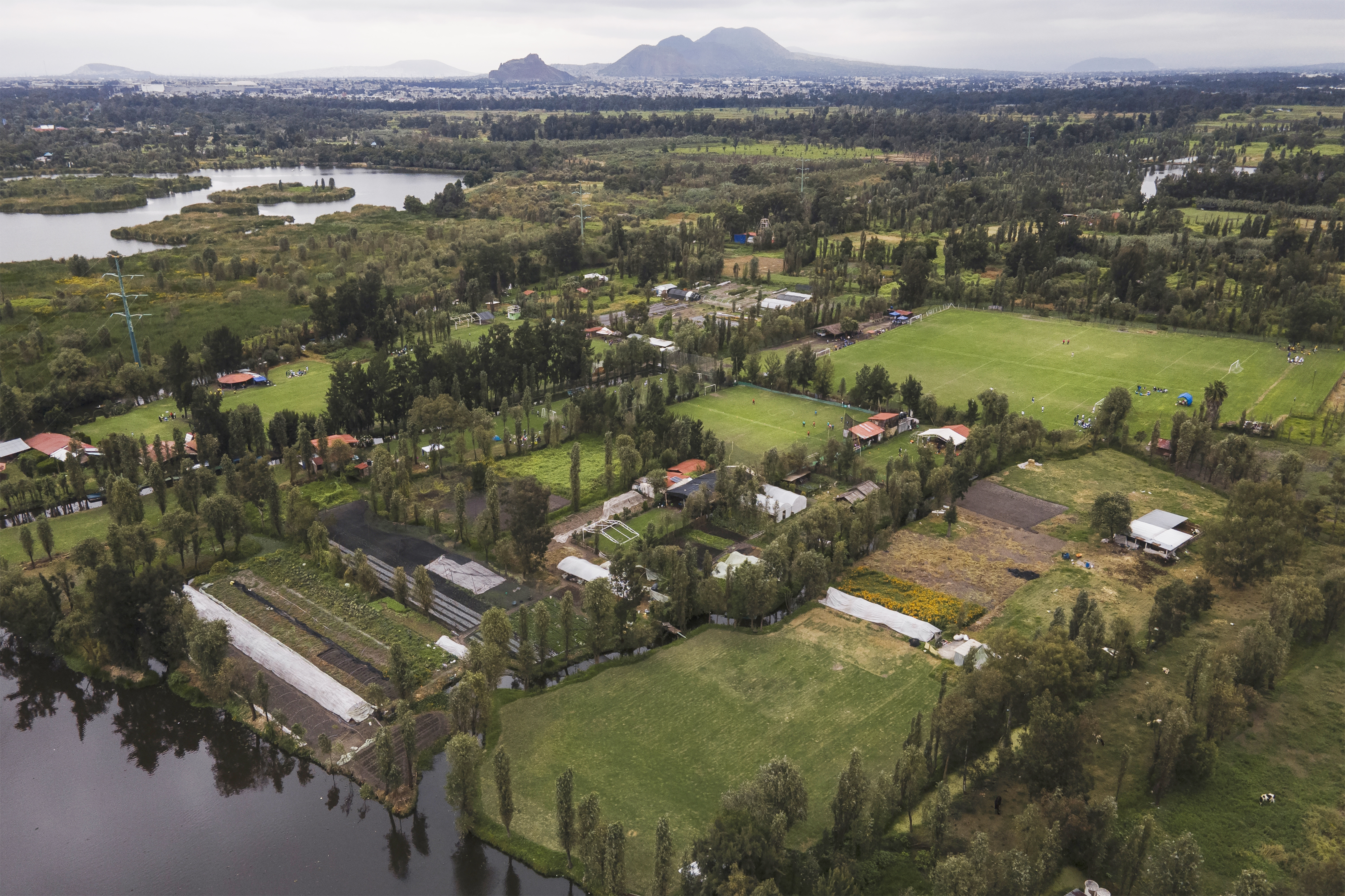 Small ancestral floating gardens are visible next to new soccer fields on the Xochimilco Lake in the Xochimilco borough of Mexico City, on Sunday, Oct. 20, 2024.<br />(Felix Marquez / AP Photo)