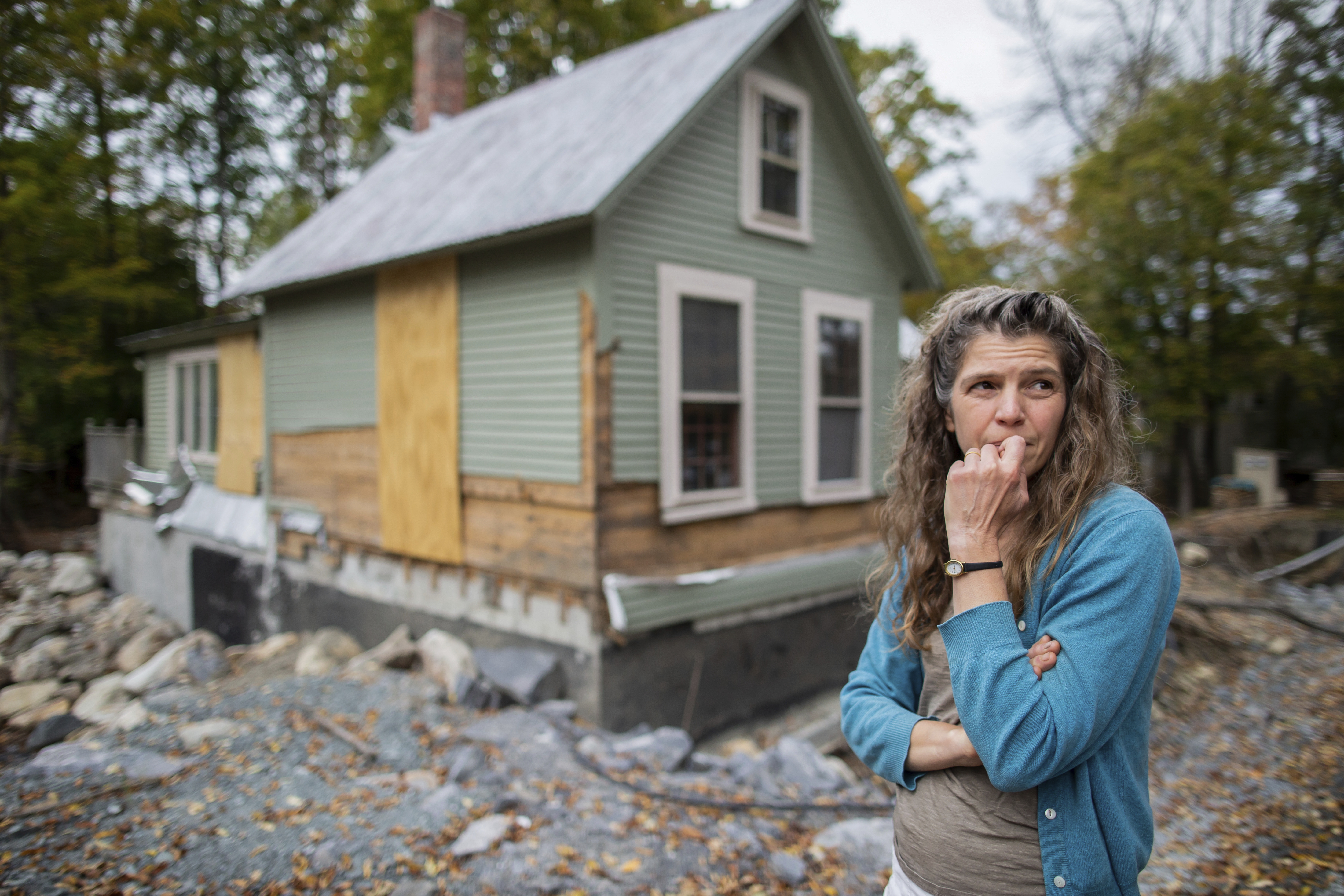 Jenny Mackenzie stands outside her flood-ravaged house in Peacham, Vt. on Sept. 23, 2024.<br /> (Dmitri Beliakov / AP Photo)