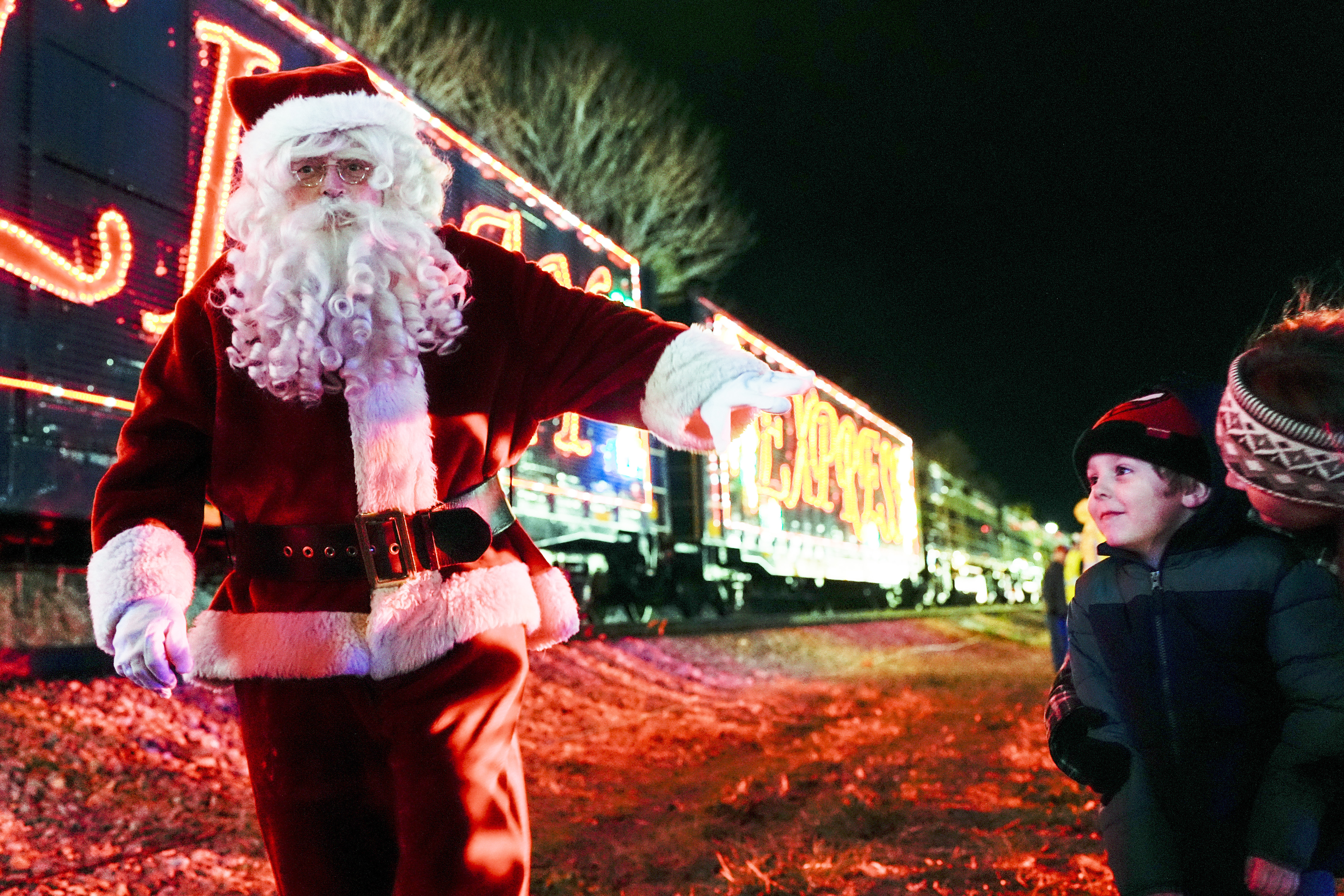 Santa Claus waves to children during a visit of the CSX Holiday Express Thursday, Nov. 21, 2024, in Erwin, Tenn. The railway company held a celebration and concert for the town affected by Hurricane Helene.<br />(George Walker IV / AP Photo)