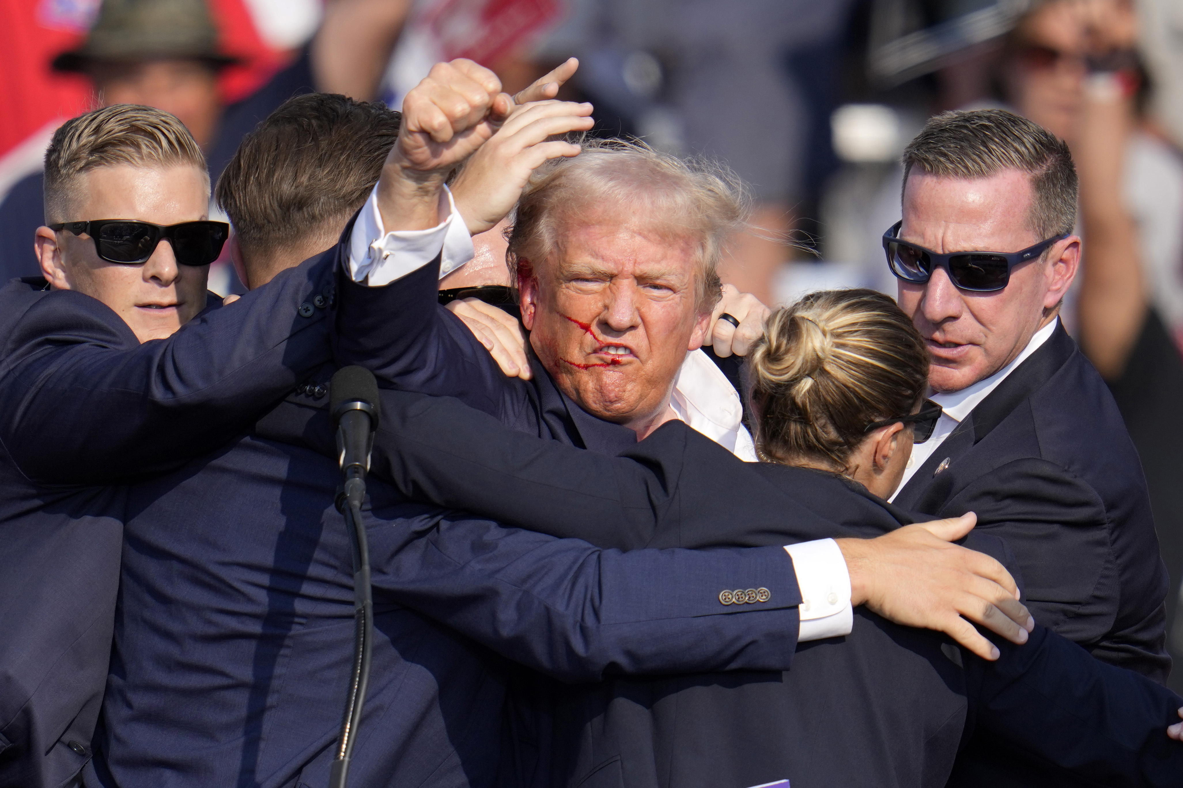 President-elect/former President Donald Trump pumps his fist as he is helped off the stage at a campaign event in Butler, Pa., on Saturday, July 13, 2024.<br />(Gene J. Puskar / AP Photo)