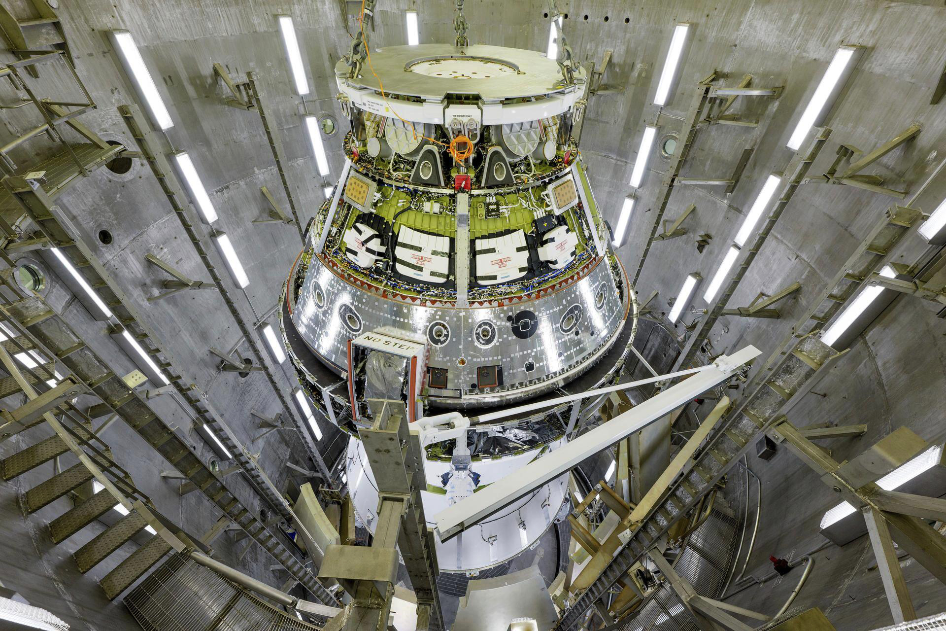 This image provided by NASA shows the Artemis II Orion spacecraft lifted from the Final Assembly and Testing (FAST) Cell and placed in the west altitude chamber inside the Operations and Checkout Building at NASA’S Kennedy Space Center in Cape Canaveral, Fla. on June 28, 2024, for a series of tests simulating deep space vacuum conditions.<br /> (Rad Sinyak / NASA via AP)