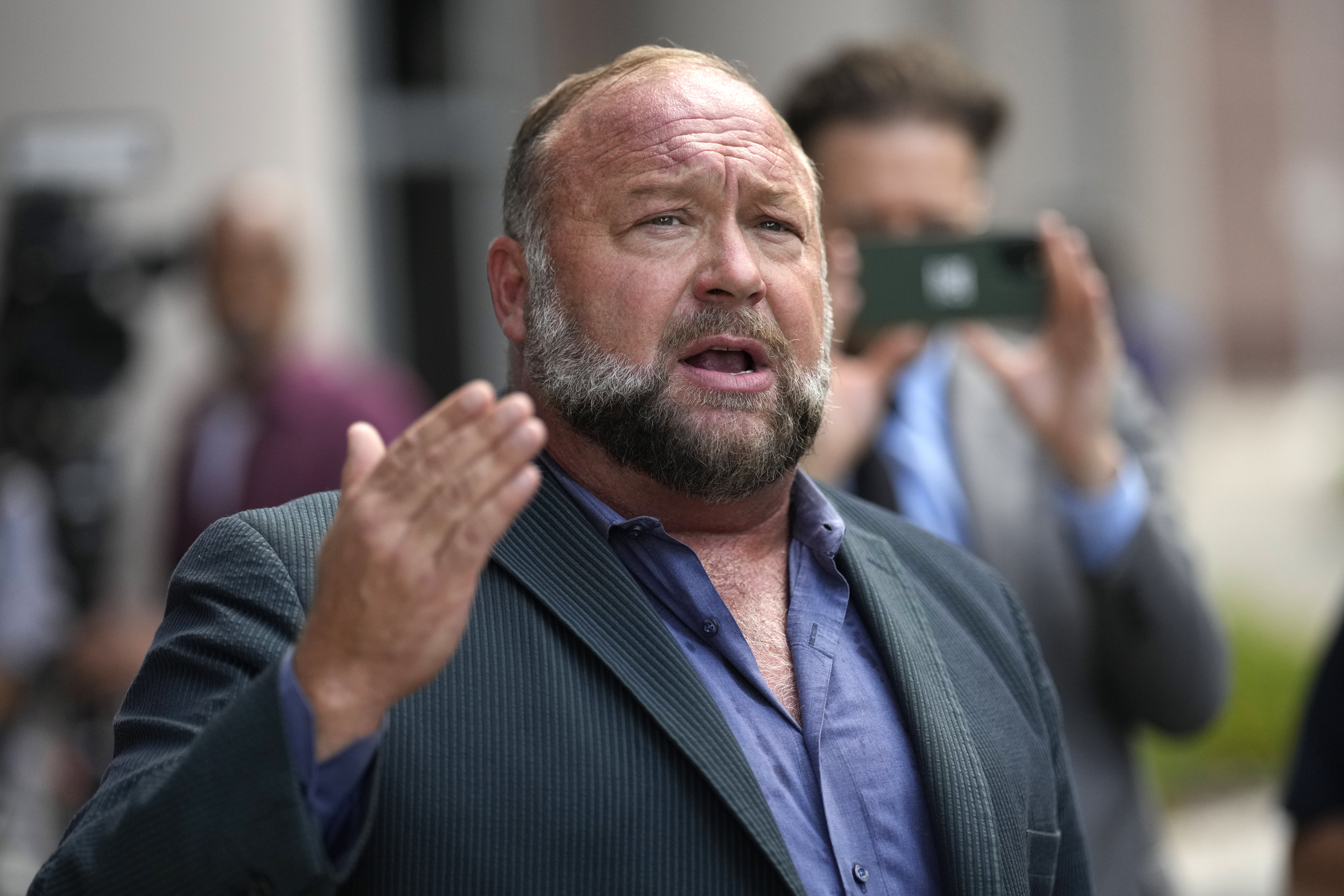 Alex Jones speaks to the media after arriving at the federal courthouse for a hearing in front of a bankruptcy judge, June 14, 2024, in Houston.<br />(David J. Phillip / AP Photo)
