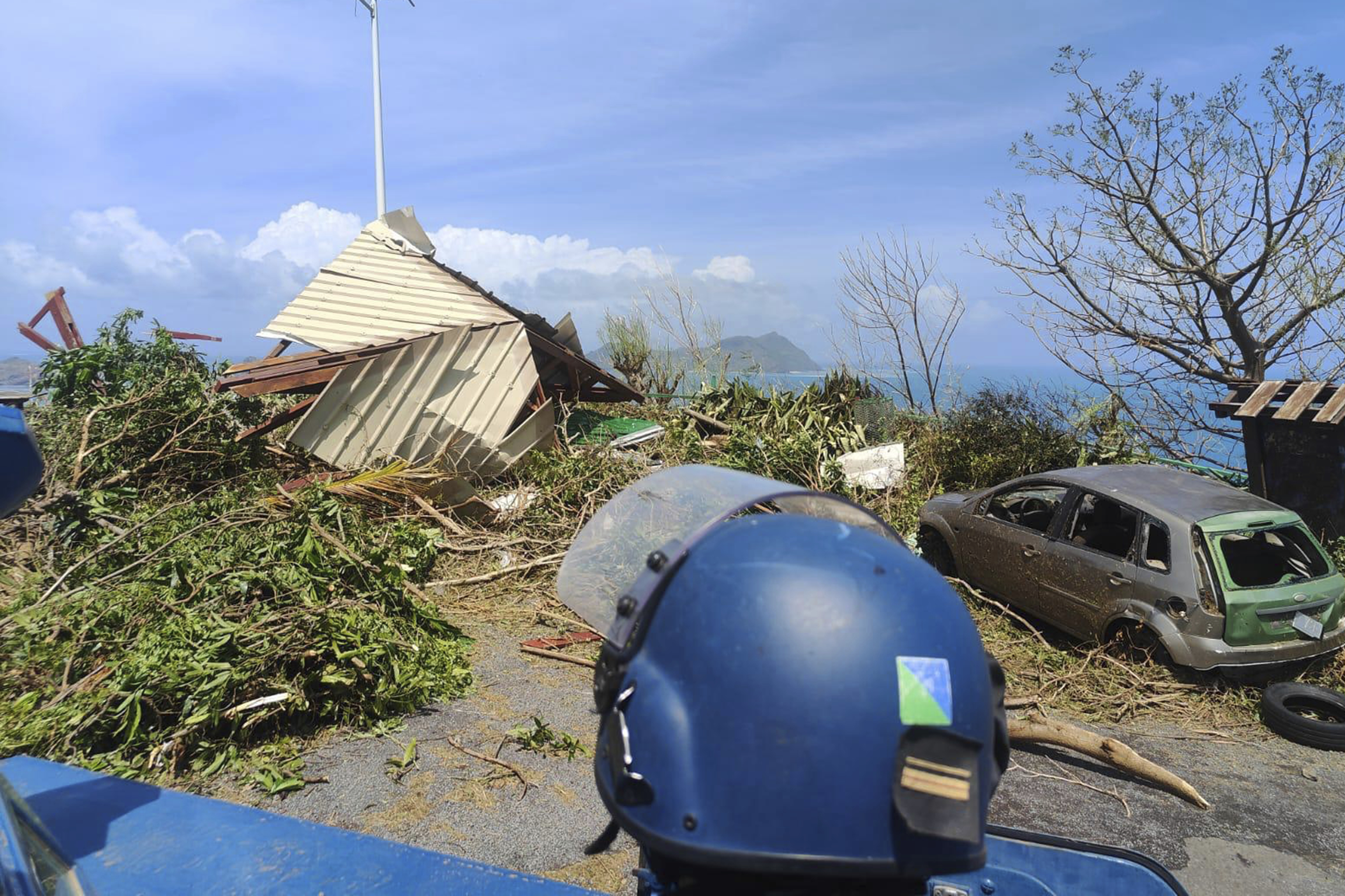 A member of the Gendarmerie Nationale looking at debris Sunday, Dec. 15, 2024 in Mayotte.<br />(Gendarmerie Nationale via AP)