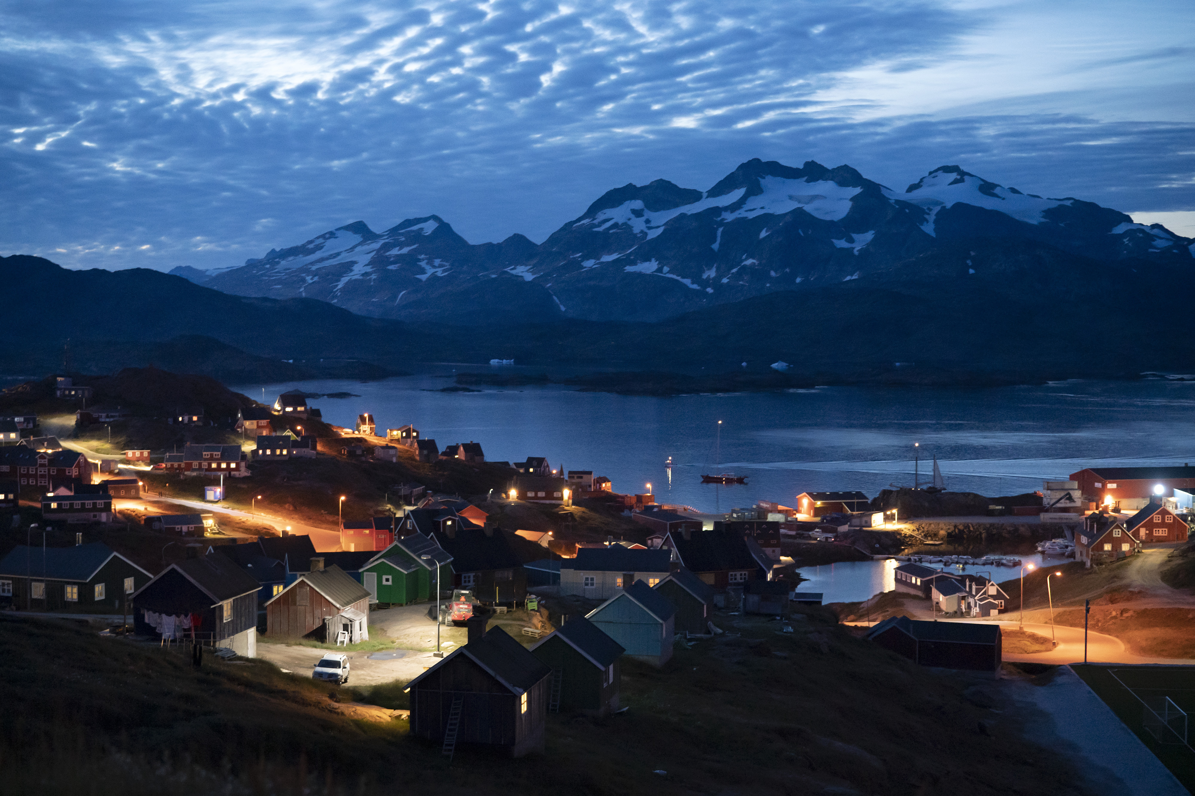 Homes are illuminated after the sunset in Tasiilaq, Greenland, Friday Aug. 16, 2019.<br />(Felipe Dana / AP Photo)