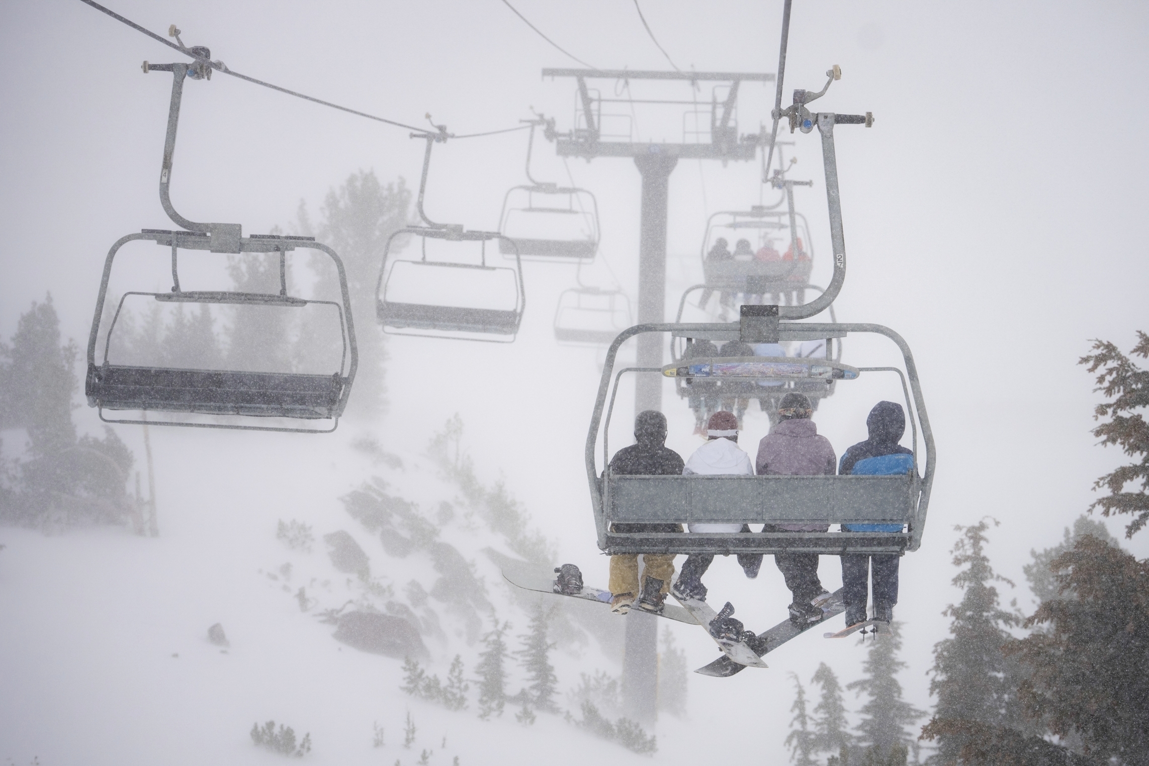 Skiers go up a lift in a snowstorm on Mammoth Mountain in Mammoth Lakes, Calif., Dec. 14, 2024.<br />(Christian Pondella / Mammoth Mountain Ski Area via AP)