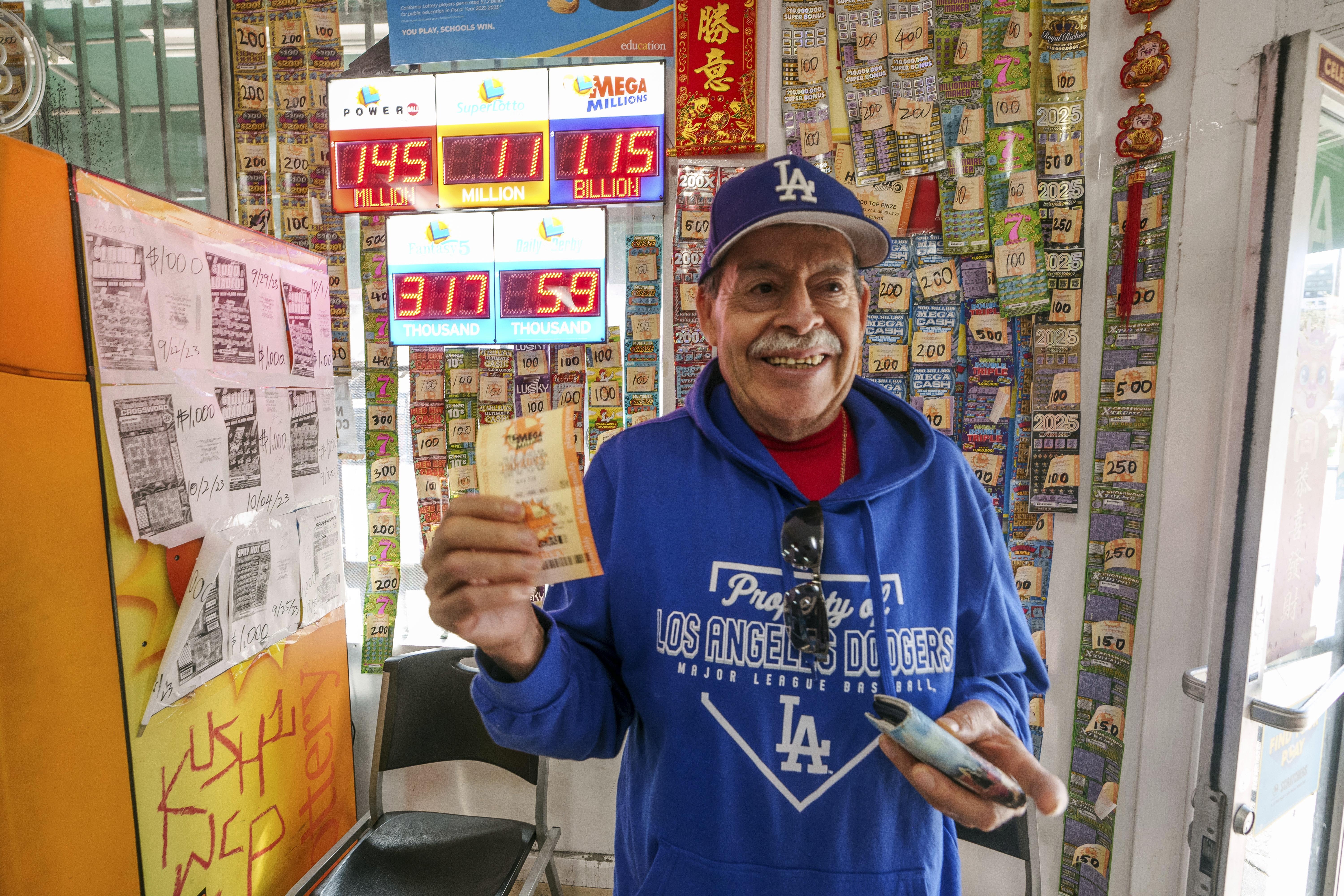 Fidel Lule buys a MegaMillion lottery ticket at Won Won Mini Mart in Chinatown Los Angeles, Thursday, Dec. 26, 2024.<br />(Damian Dovarganes / AP Photo)
