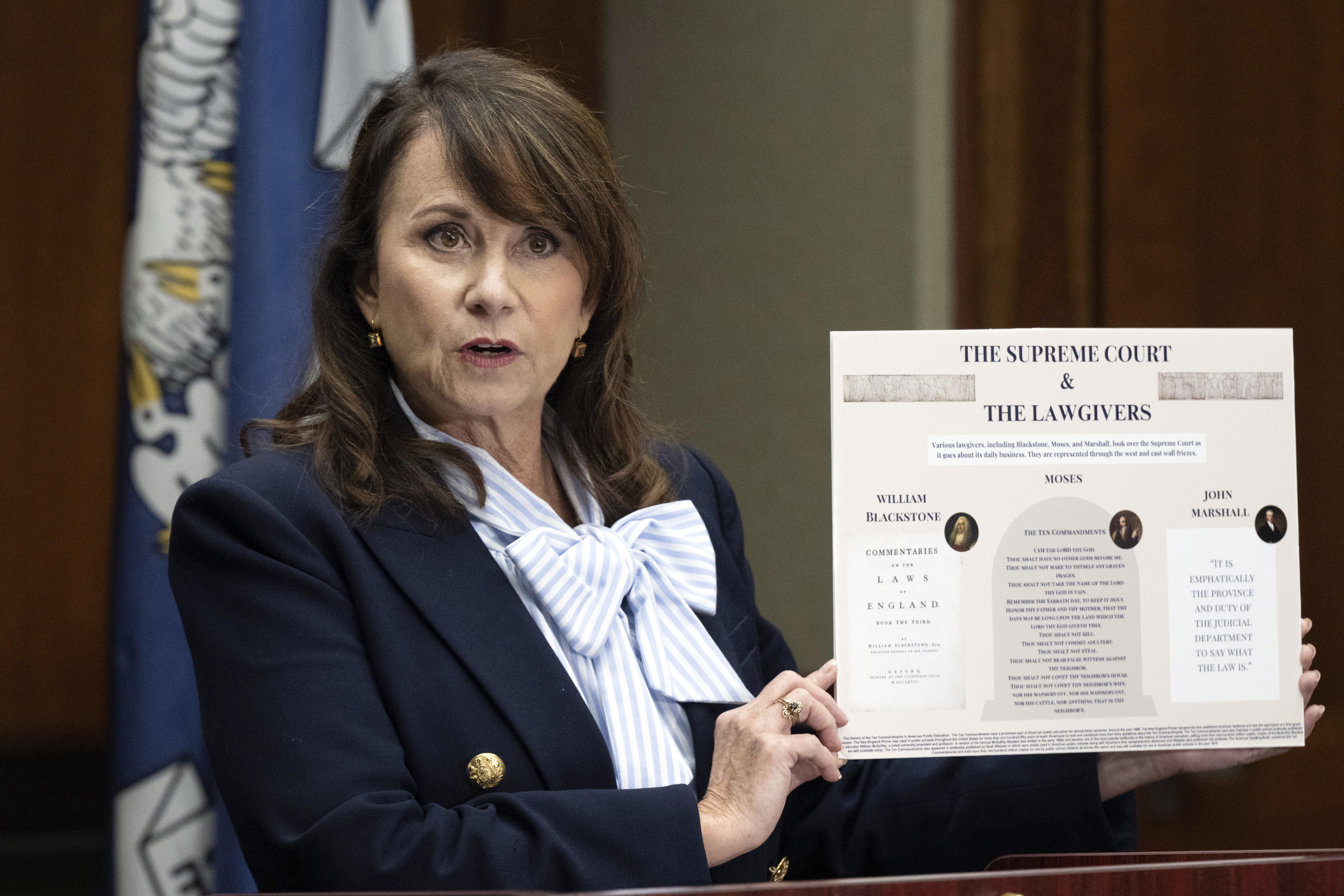 Louisiana Attorney General Liz Murrill holds up a mini-display showing the Ten Commandments during a press conference regarding the Ten Commandments in schools, Aug. 5, 2024, in Baton Rouge, La.<br />(Hilary Scheinuk / The Advocate via AP)