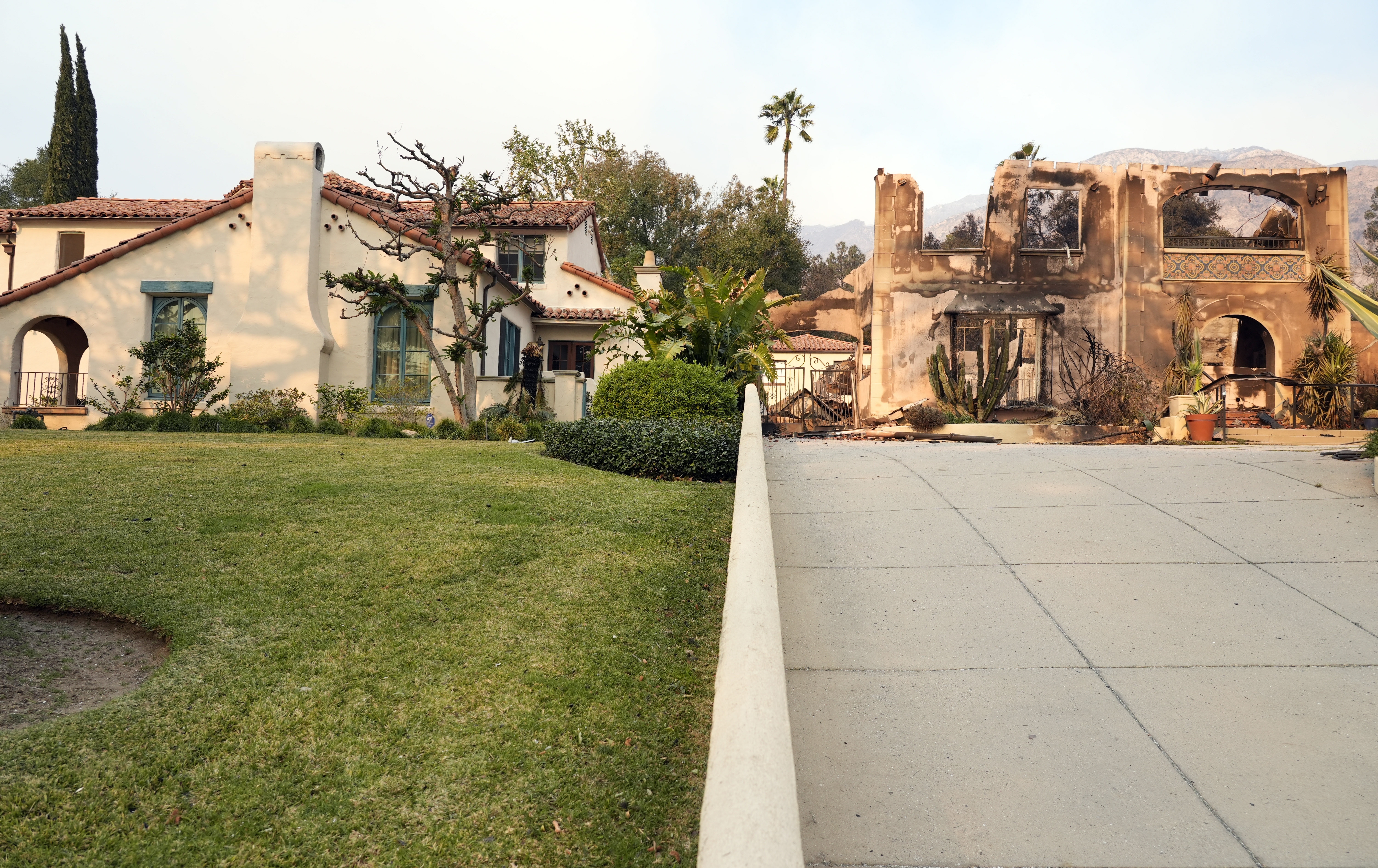 Photos after the Los Angeles fires in January 2025 show many yards where vegetation didn’t burn while neighboring houses did.<br />(Chris Pizzello / AP Photo)