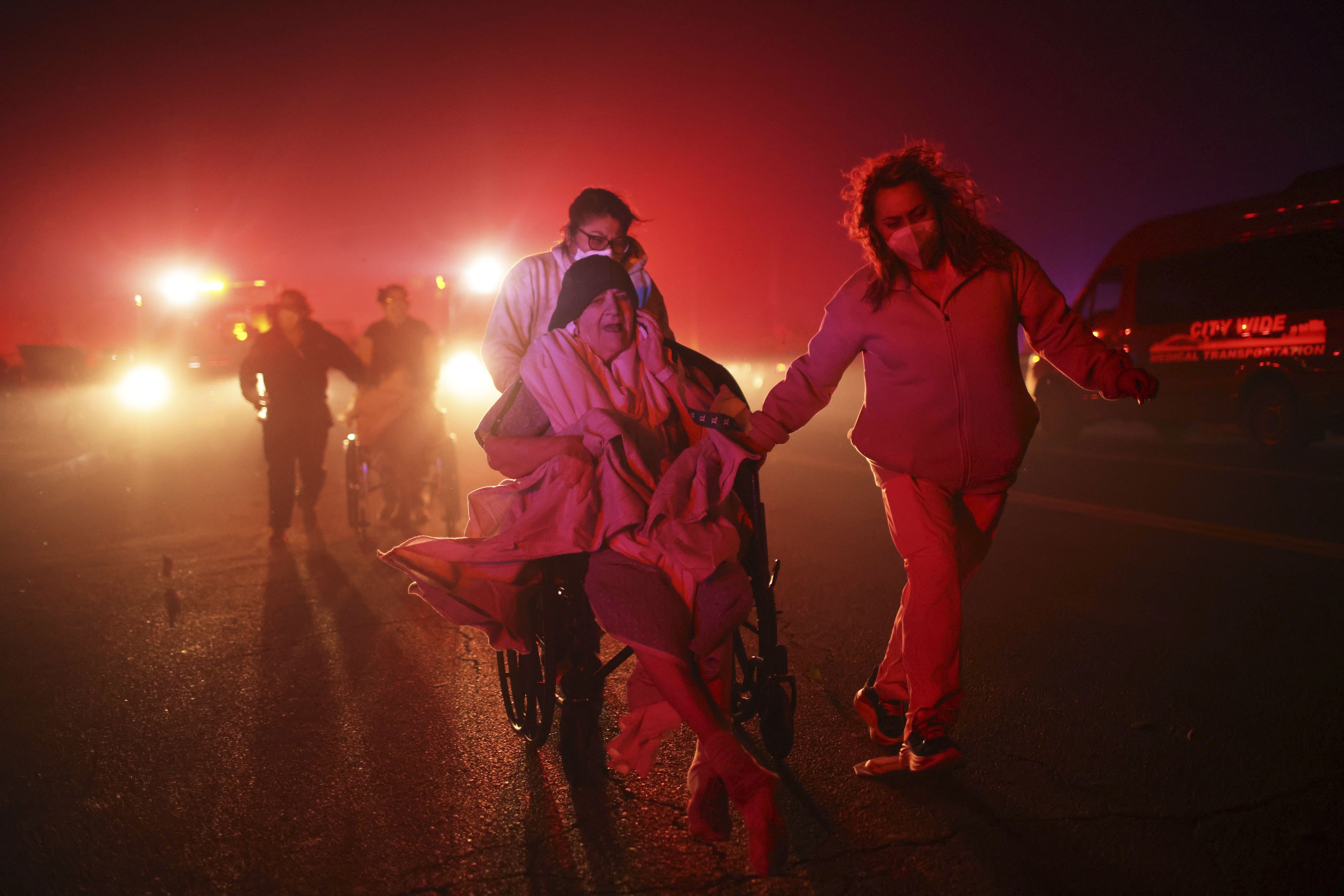 Residents and staff at Pasadena Park Healthcare &amp; Wellness Center evacuate as the Eaton Fire approaches on Jan. 7, 2025, in Altadena, Calif.<br />(Ethan Swope / AP Photo)