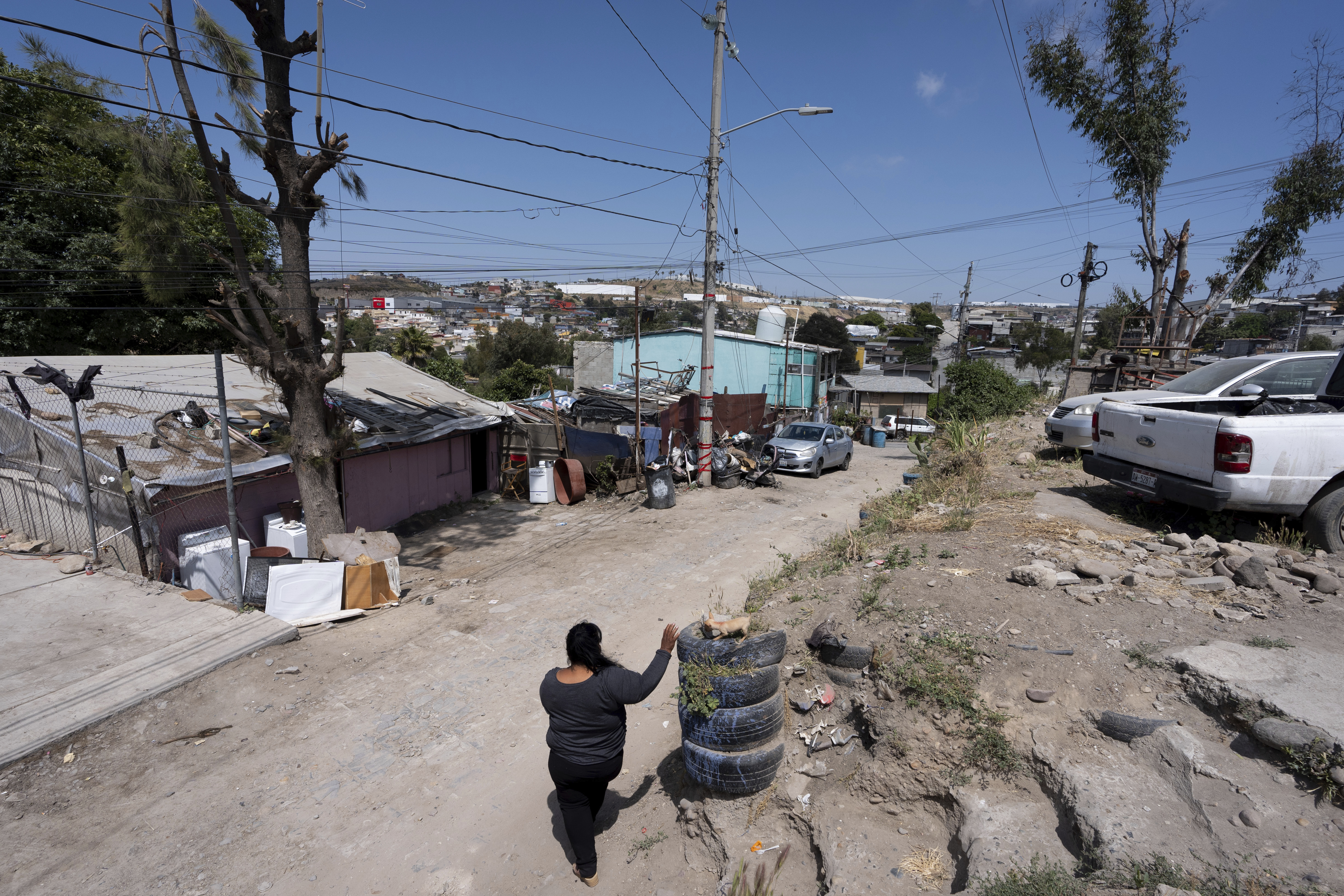 Martha Rosales walks back to her home where she houses Cuban migrants as they wait for an appointment to apply for asylum in the United States through the CBP One app Wednesday, May 22, 2024, in Tijuana, Mexico.<br />(Gregory Bull / AP Photo)