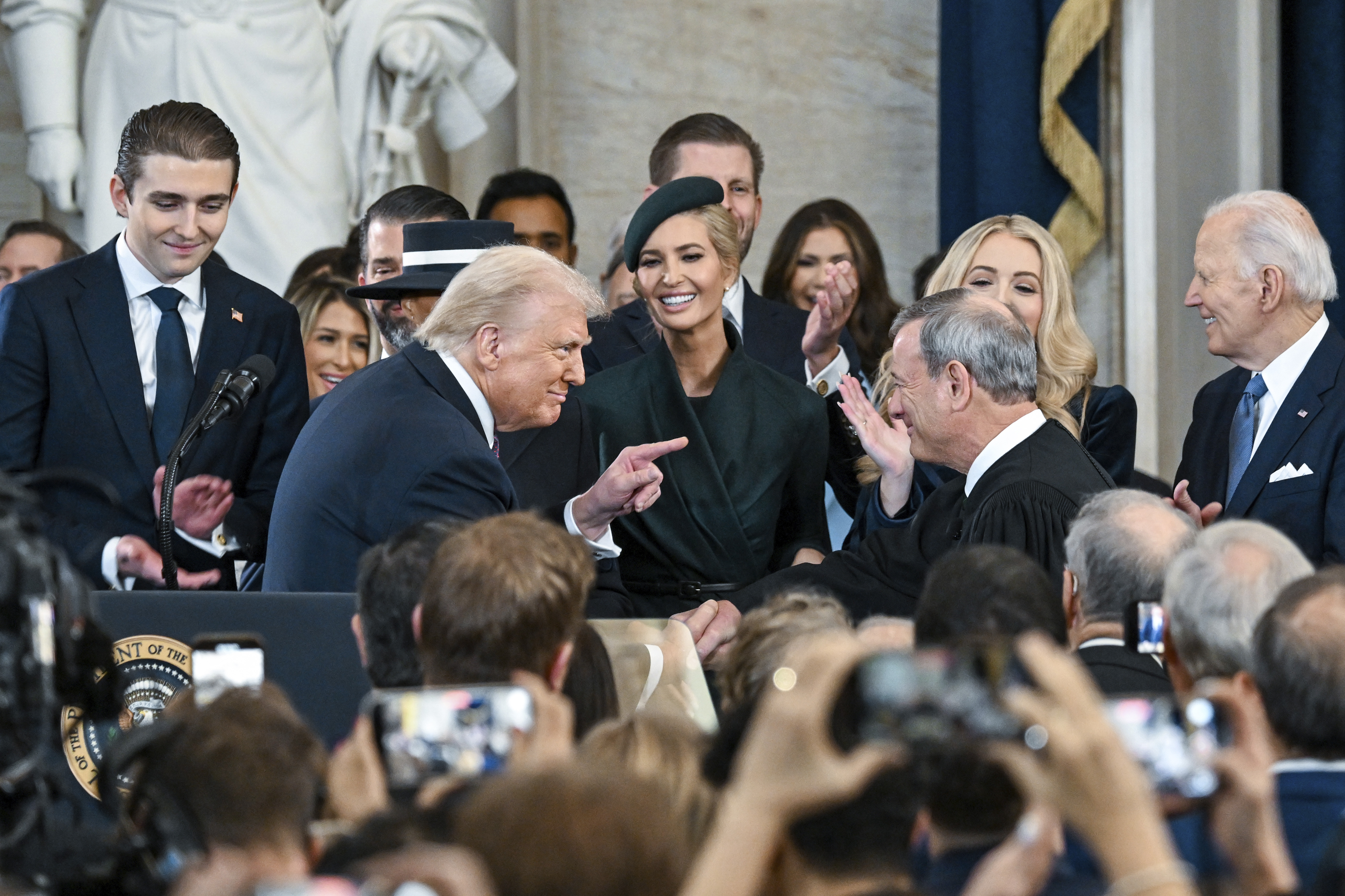 President Donald Trump, left, points to Supreme Court Chief Justice John Roberts after taking the oath of office during the 60th Presidential Inauguration in the Rotunda of the U.S. Capitol in Washington, Monday, Jan. 20, 2025.<br />(Kenny Holston / The New York Times via AP)