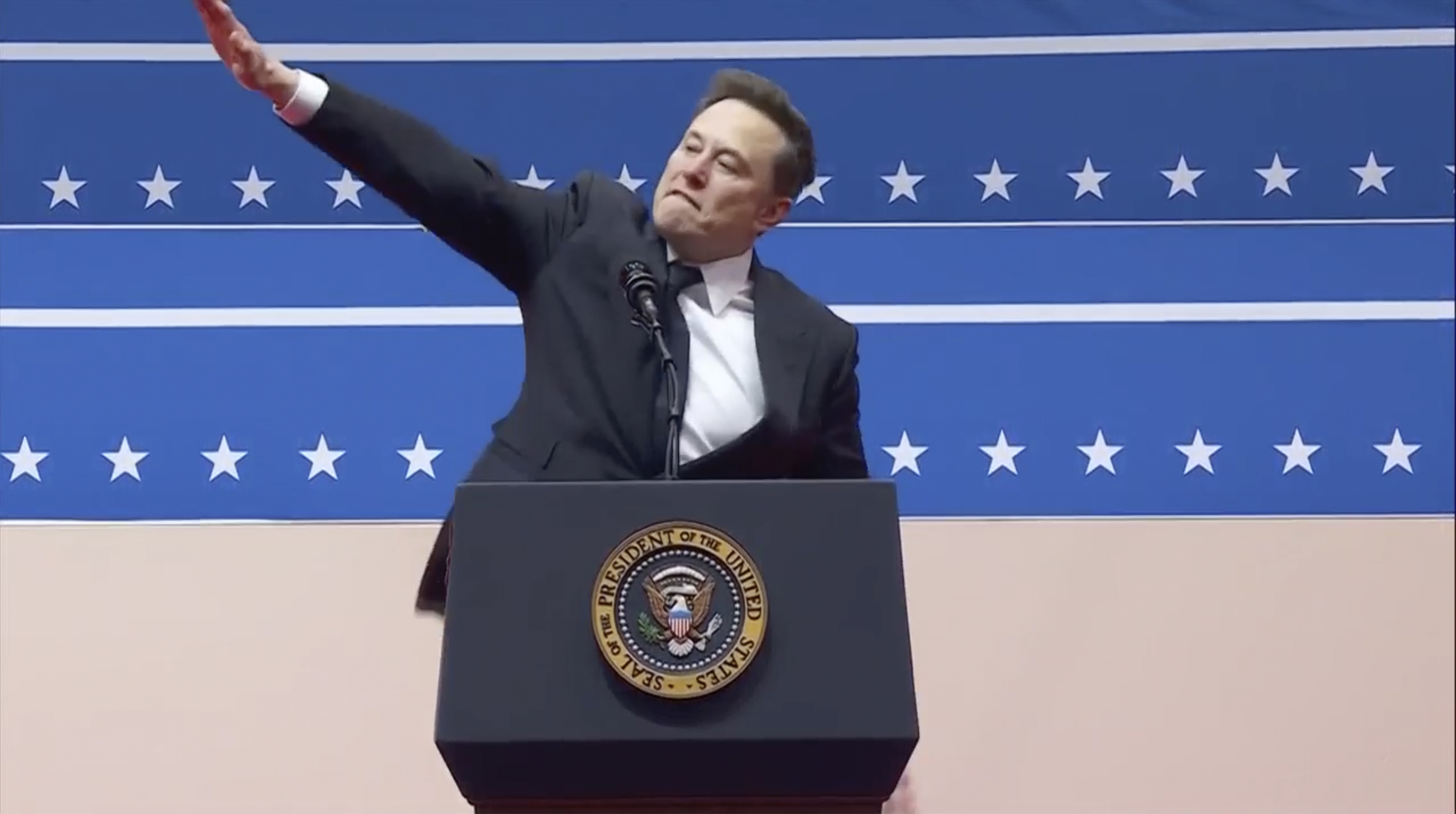 Elon Musk gestures while speaking at an indoor Presidential Inauguration parade event in Washington, Monday, Jan. 20, 2025.<br />(AP Photo)