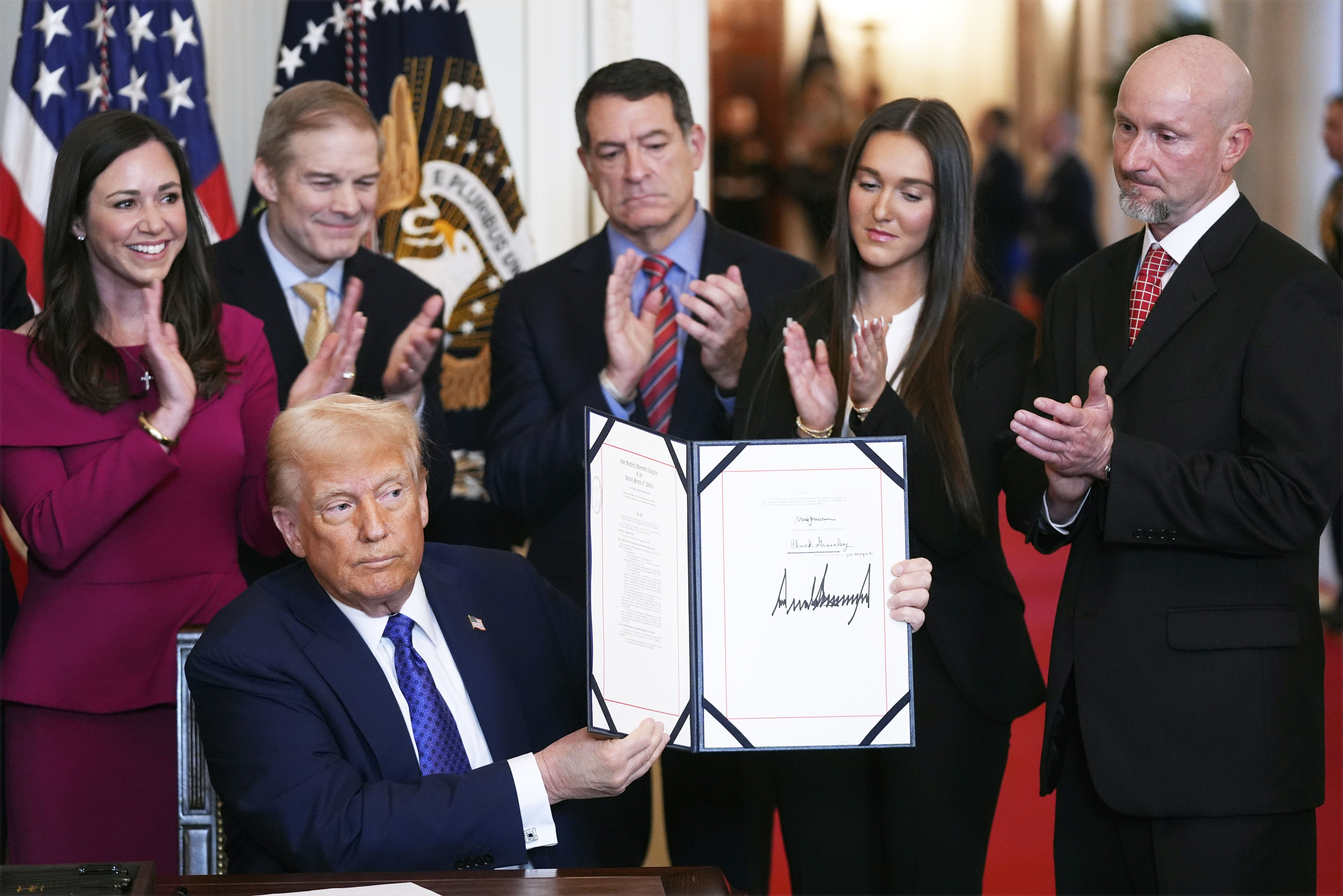 President Donald Trump holds the document after signing the Laken Riley Act during an event in the East Room of the White House, Wednesday, Jan. 29, 2025, in Washington.<br />(Evan Vucci / AP Photo)