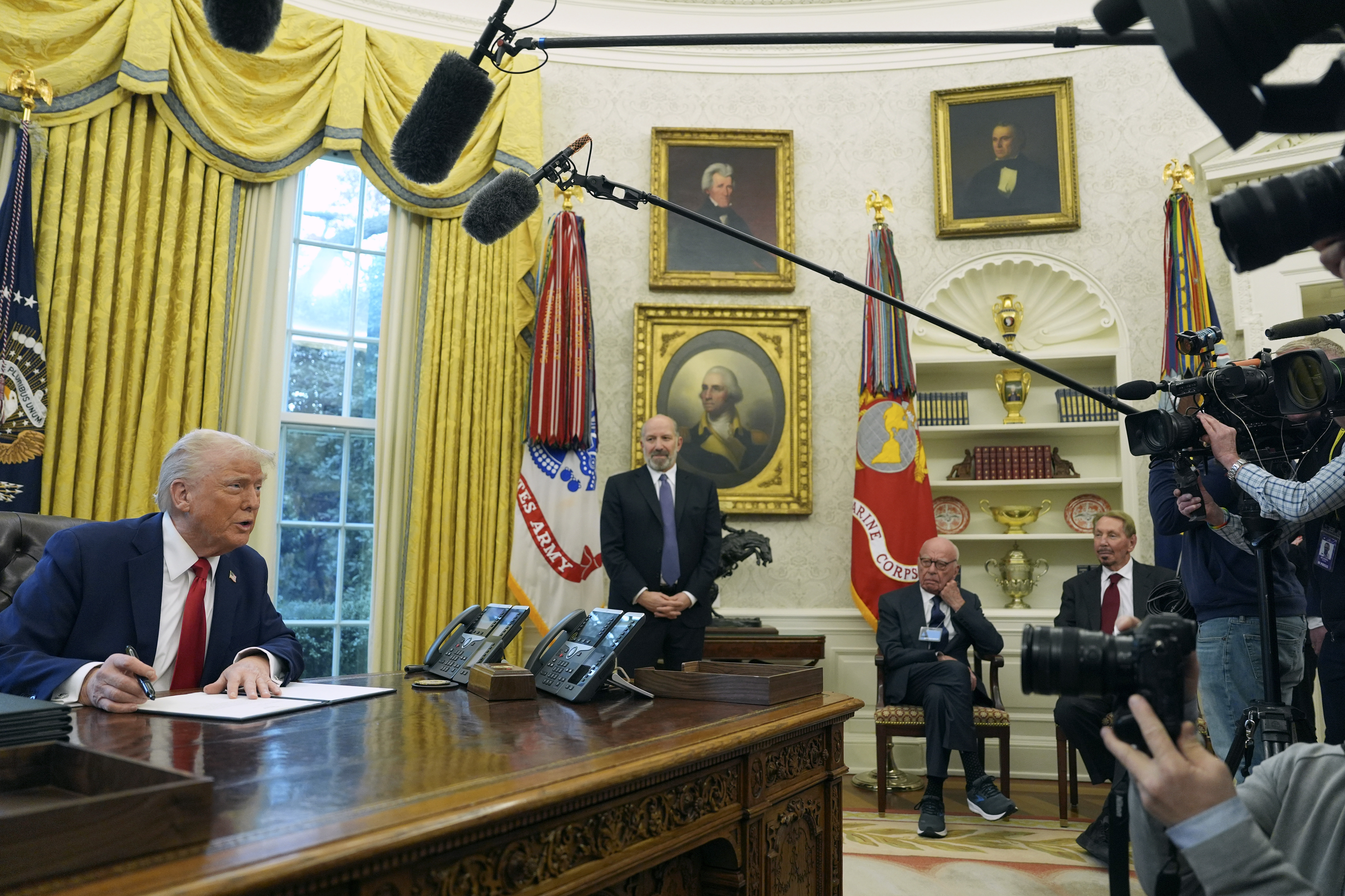 President Donald Trump (from left) speaks while signing an executive order as Commerce Secretary nominee Howard Lutnick, Rupert Murdoch and Larry Ellison, chairman and chief technology officer of Oracle Corporation, listen in the Oval Office of the White House, Monday, Feb. 3, 2025, in Washington.<br />(Evan Vucci / AP Photo)