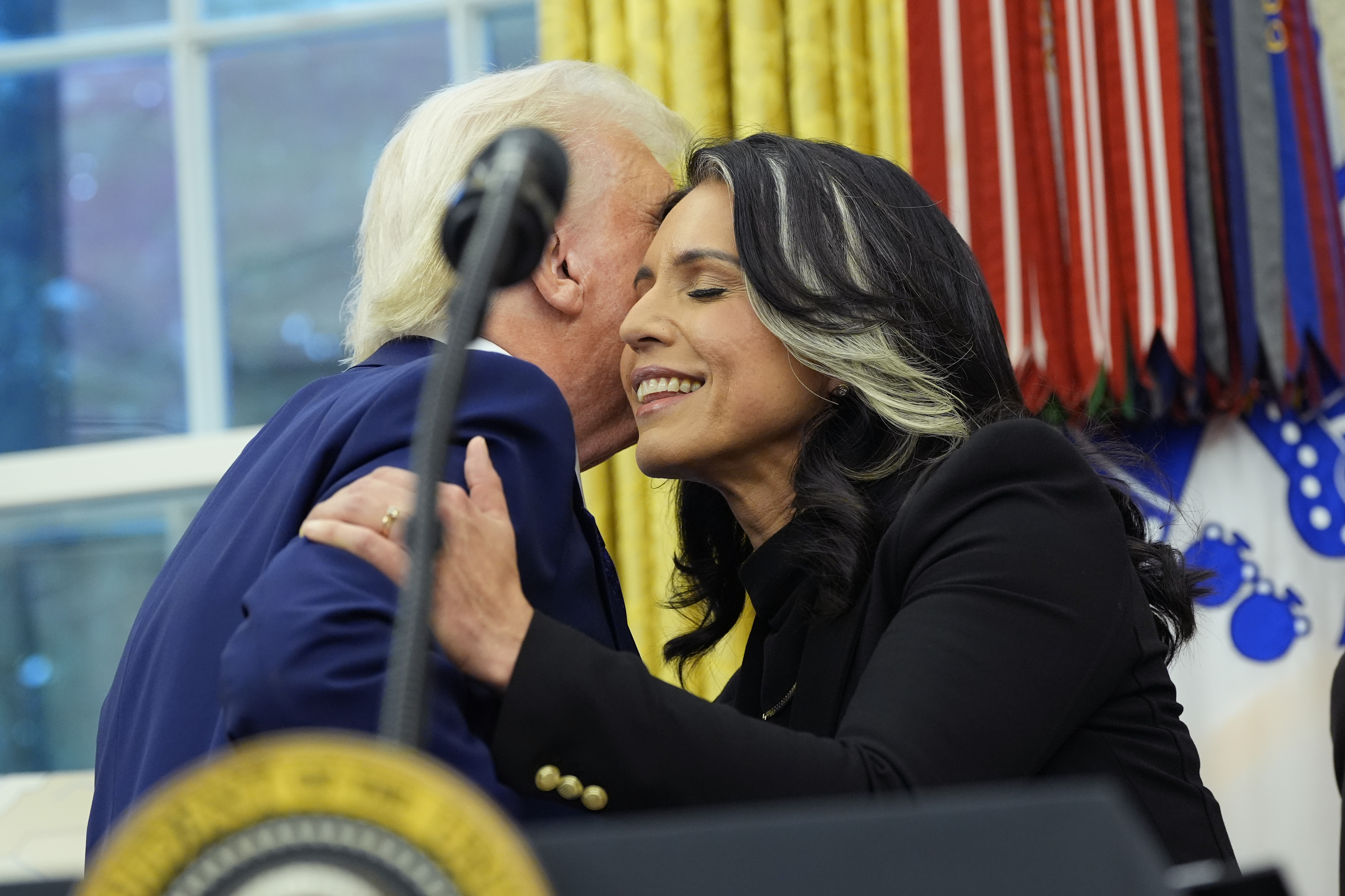 President Donald Trump congratulates Tulsi Gabbard after she was sworn in as the Director of National Intelligence in the Oval Office of the White House, Wednesday, Feb. 12, 2025, in Washington.<br />(Alex Brandon / AP Photo)