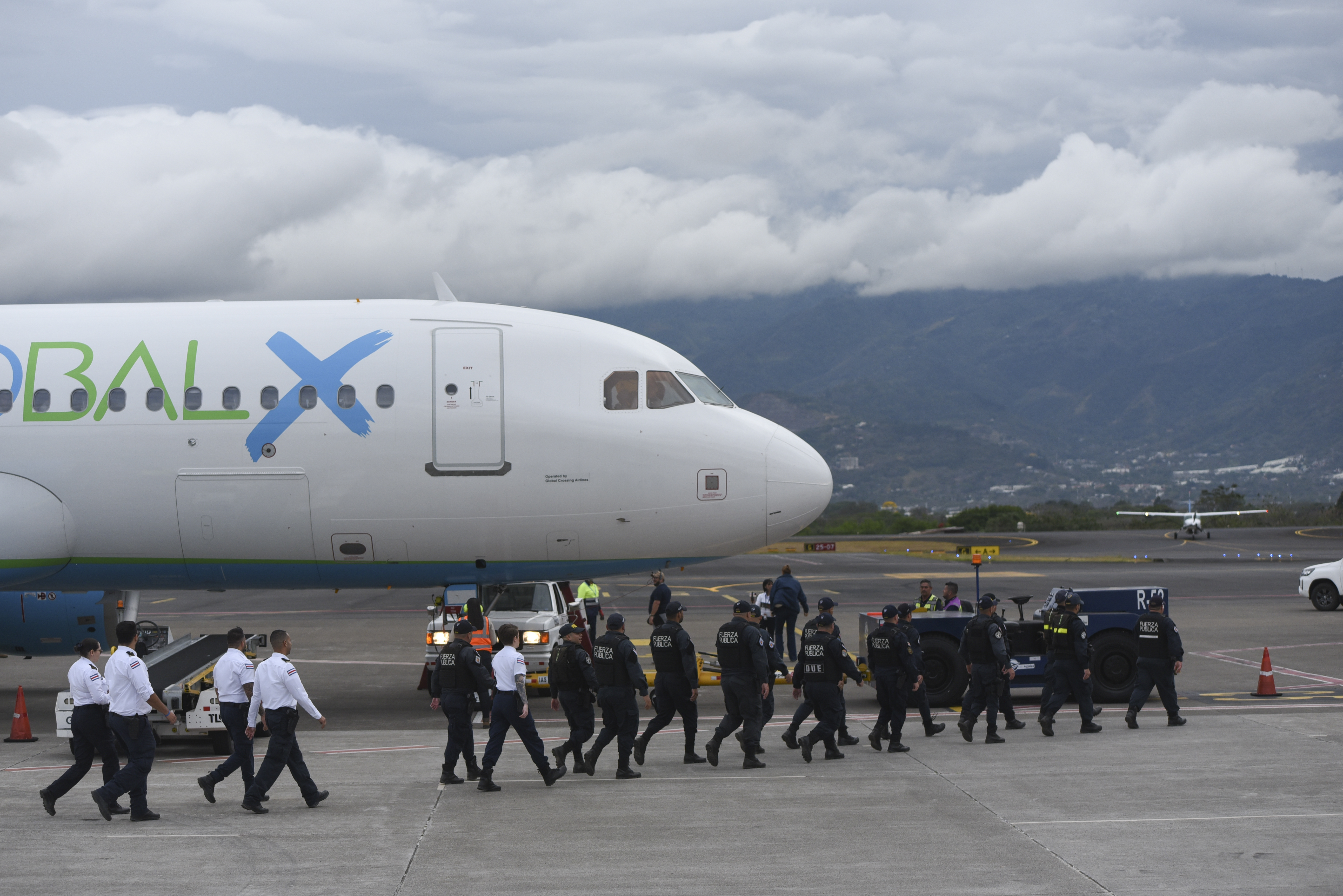 Security personnel approach a plane carrying migrants from Central Asia and India, deported from the United States, at Juan Santamaría International Airport in San Jose, Costa Rica, Thursday, Feb. 20, 2025.<br />(Jose Diaz / AP Photo)