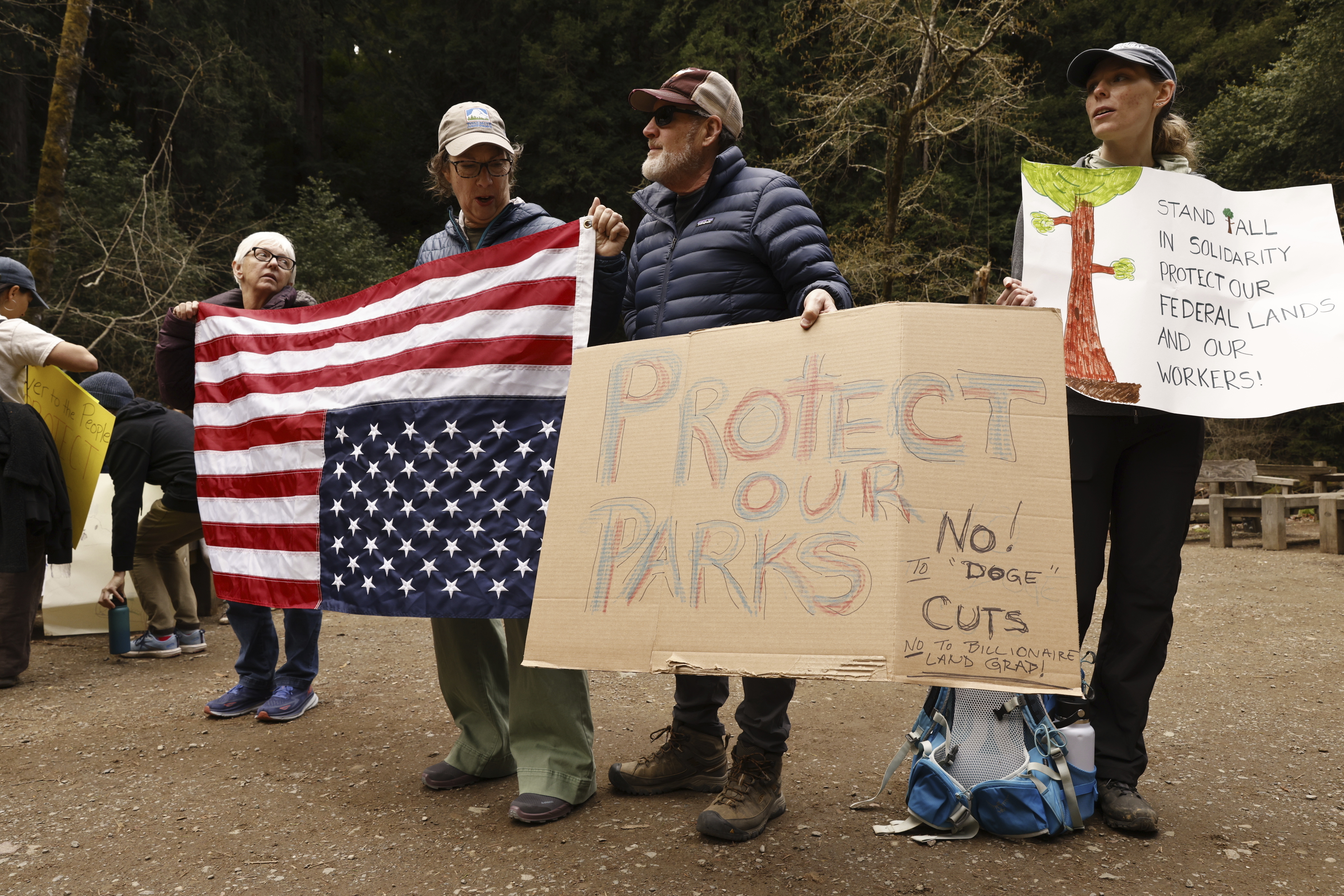 Demonstrators hold signs in protest of the Trump administration&#039;s firing of National Park Service employees at Muir Woods National Monument in Marin County, Calif., Saturday, March 1, 2025.<br />(Santiago Mejia / San Francisco Chronicle via AP)
