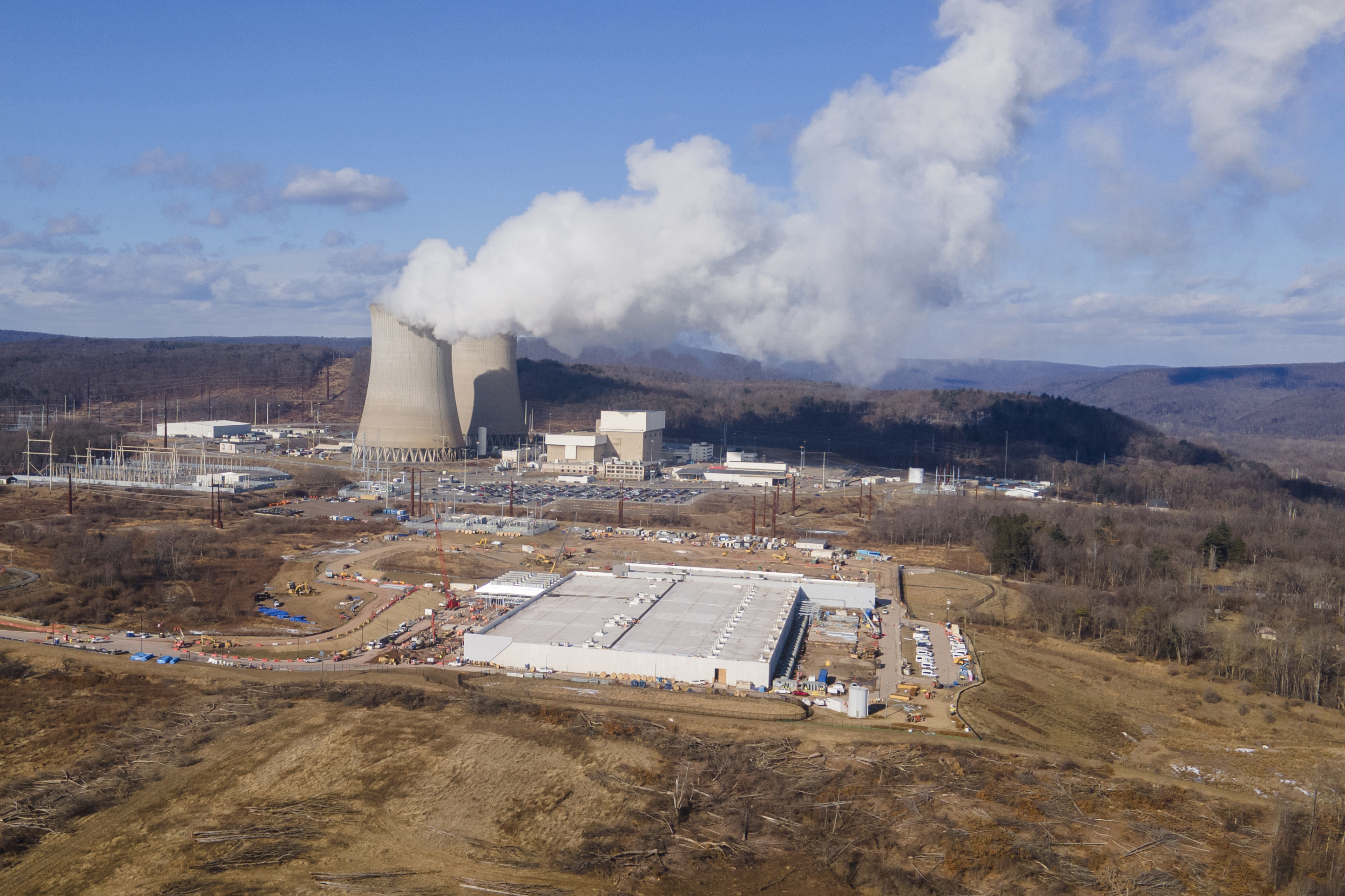 A data center owned by Amazon Web Services (front right) is under construction next to the Susquehanna nuclear power plant in Berwick, Pa., on Tuesday, Jan. 14, 2024.<br />(Ted Shaffrey / AP Photo)