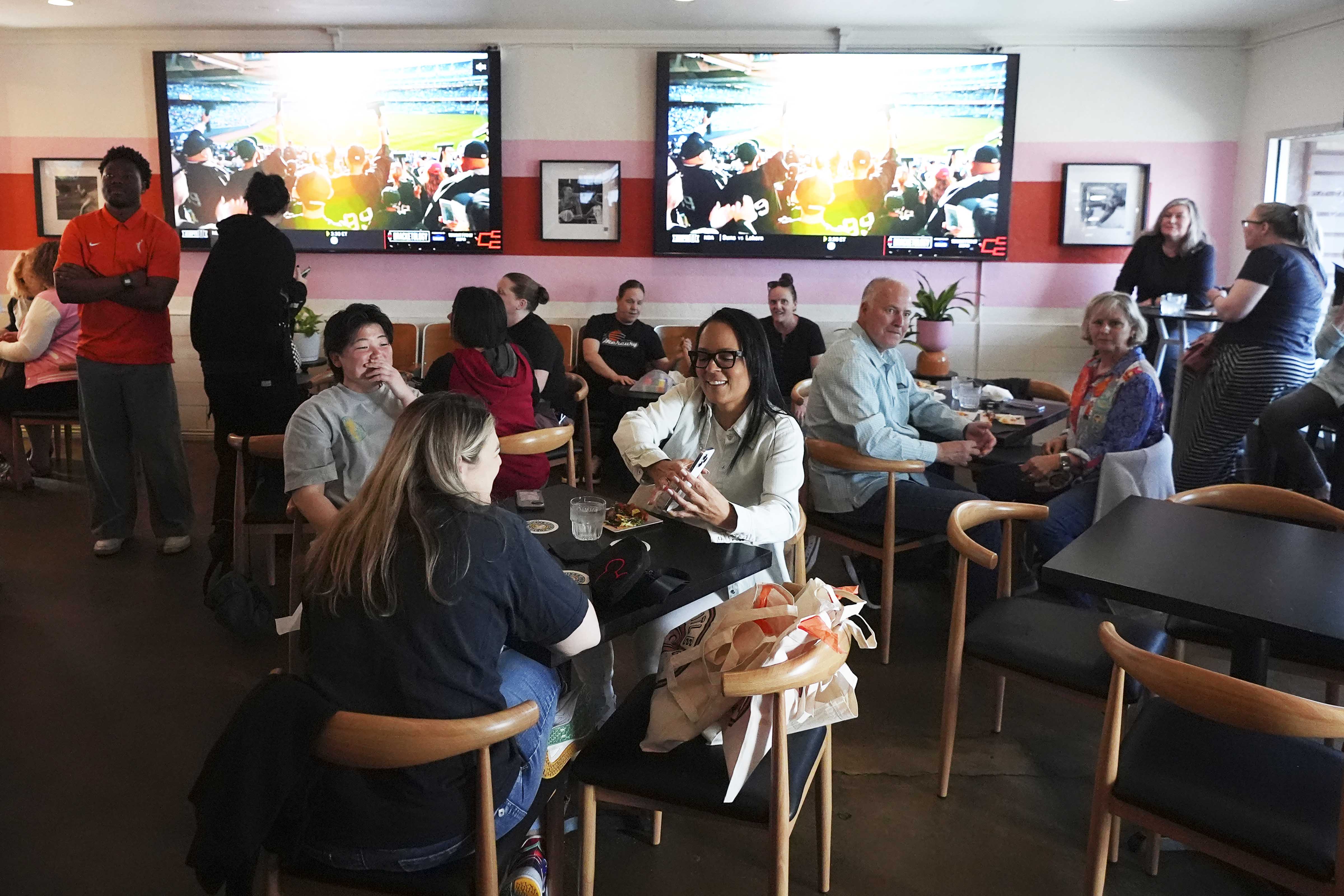 Patrons attend the grand opening of the Title 9 Sports Grill, Sunday, March 16, 2025, in Phoenix.<br />(Ross D. Franklin / AP Photo)