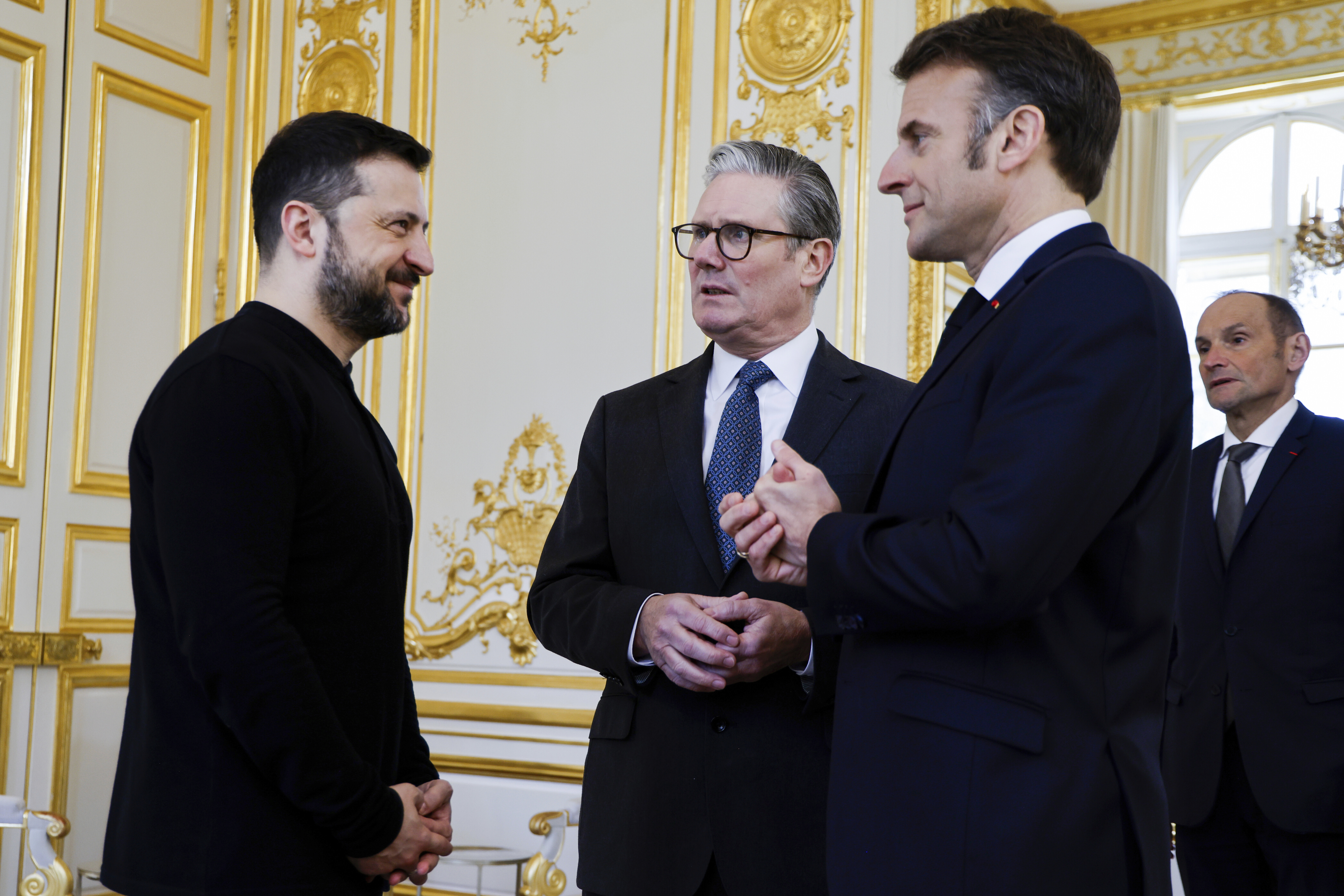 Ukraine&#039;s President Volodymyr Zelenskyy (left) French President Emmanuel Macron (right) and Britain&#039;s Prime Minister Keir Starmer speak during a trilateral meeting on the sidelines of a summit for &quot;coalition of the willing&quot; at the Elysee Palace, Thursday, March 27, 2025.<br />(Ludovic Marin / Pool via AP)