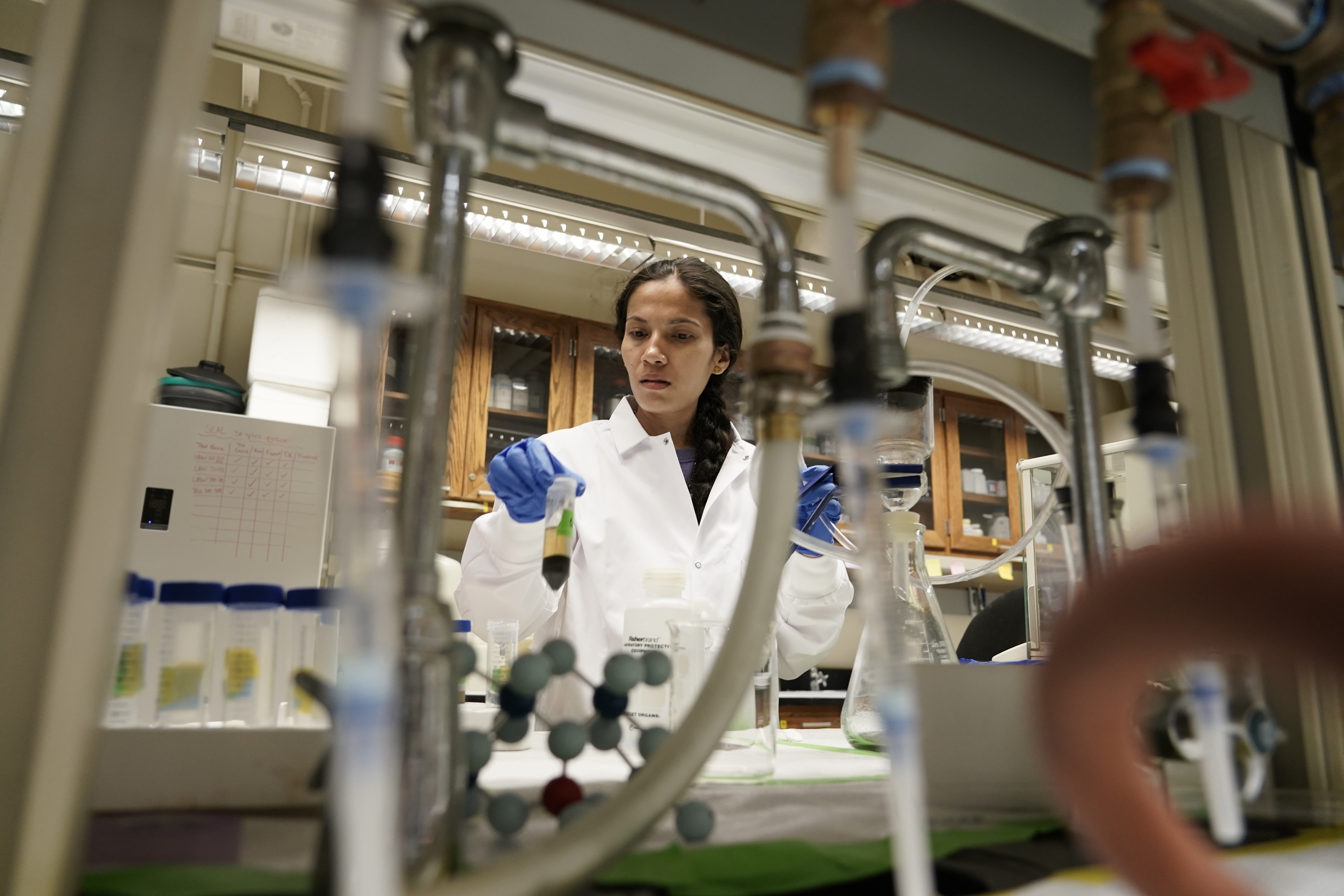 Soil researcher Asmita Gautam, a Ph.D. candidate at Purdue University, prepares a soil sample for carbon content analysis, July 13, 2023, in West Lafayette, Ind.<br />(Joshua A. Bickel / AP Photo)