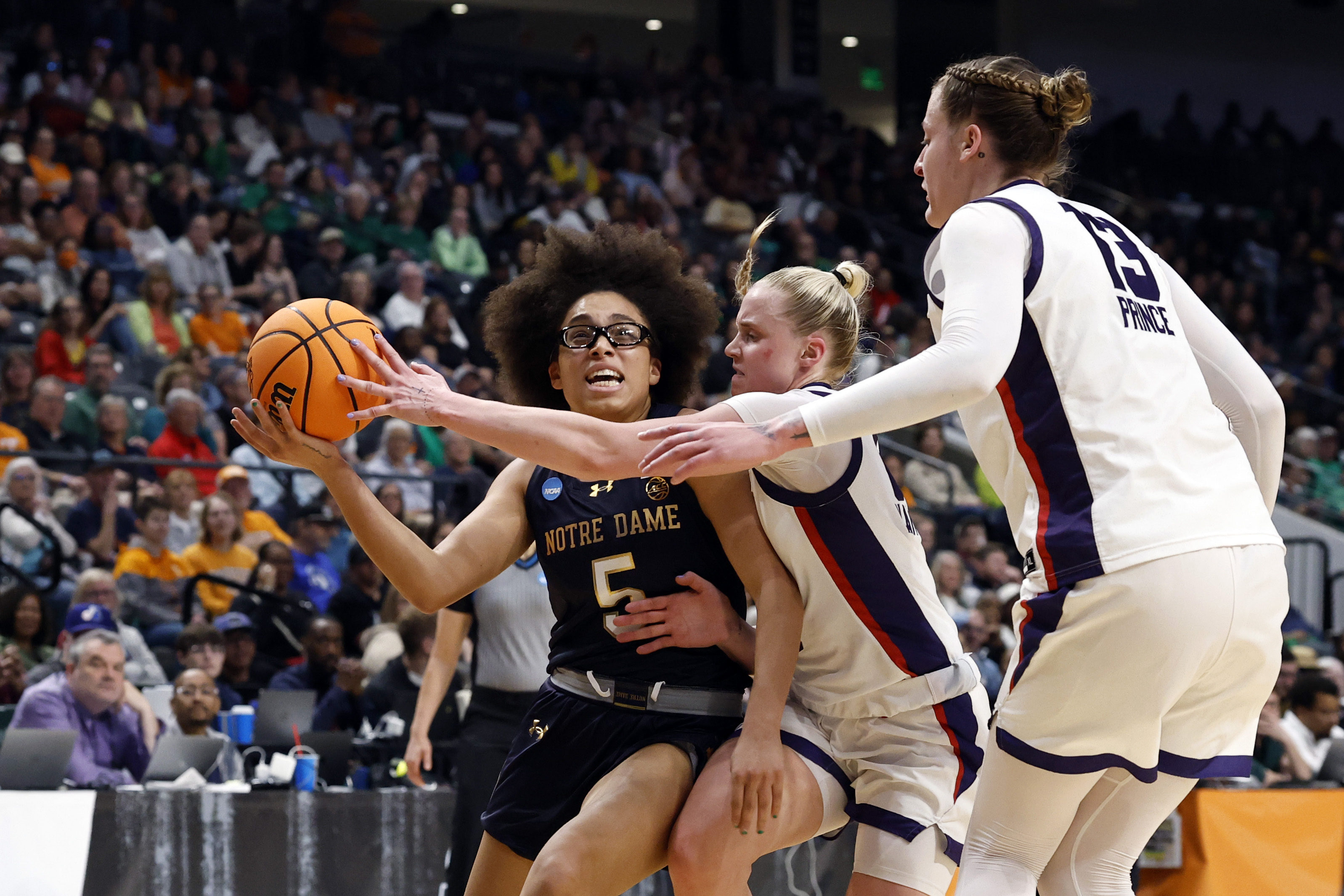 Notre Dame guard Olivia Miles (5) is fouled by TCU guard Hailey Van Lith (10) as she drives to the basket during the first half in the Sweet 16 of the NCAA college basketball tournament, Saturday, March 29, 2025, in Birmingham, Ala.<br />(Butch Dill / AP Photo)