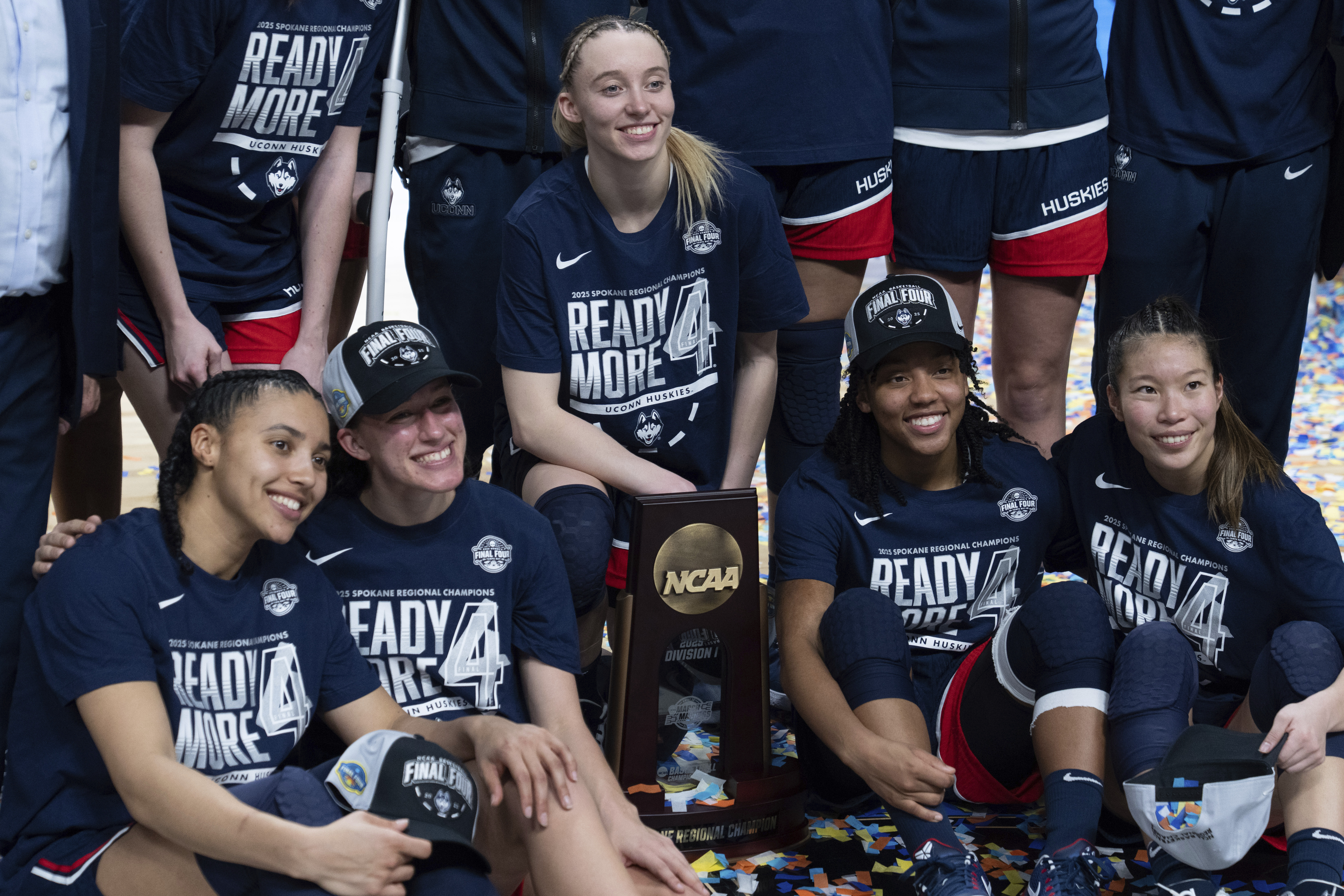 UConn players from left: Azzi Fudd, Ashlynn Shade, Paige Bueckers, KK Arnold and Kaitlyn Chen pose with the trophy after a game against Southern California in the Elite Eight of the NCAA college basketball tournament Monday, March 31, 2025, in Spokane, Wash.<br />(Jenny Kane / AP Photo)