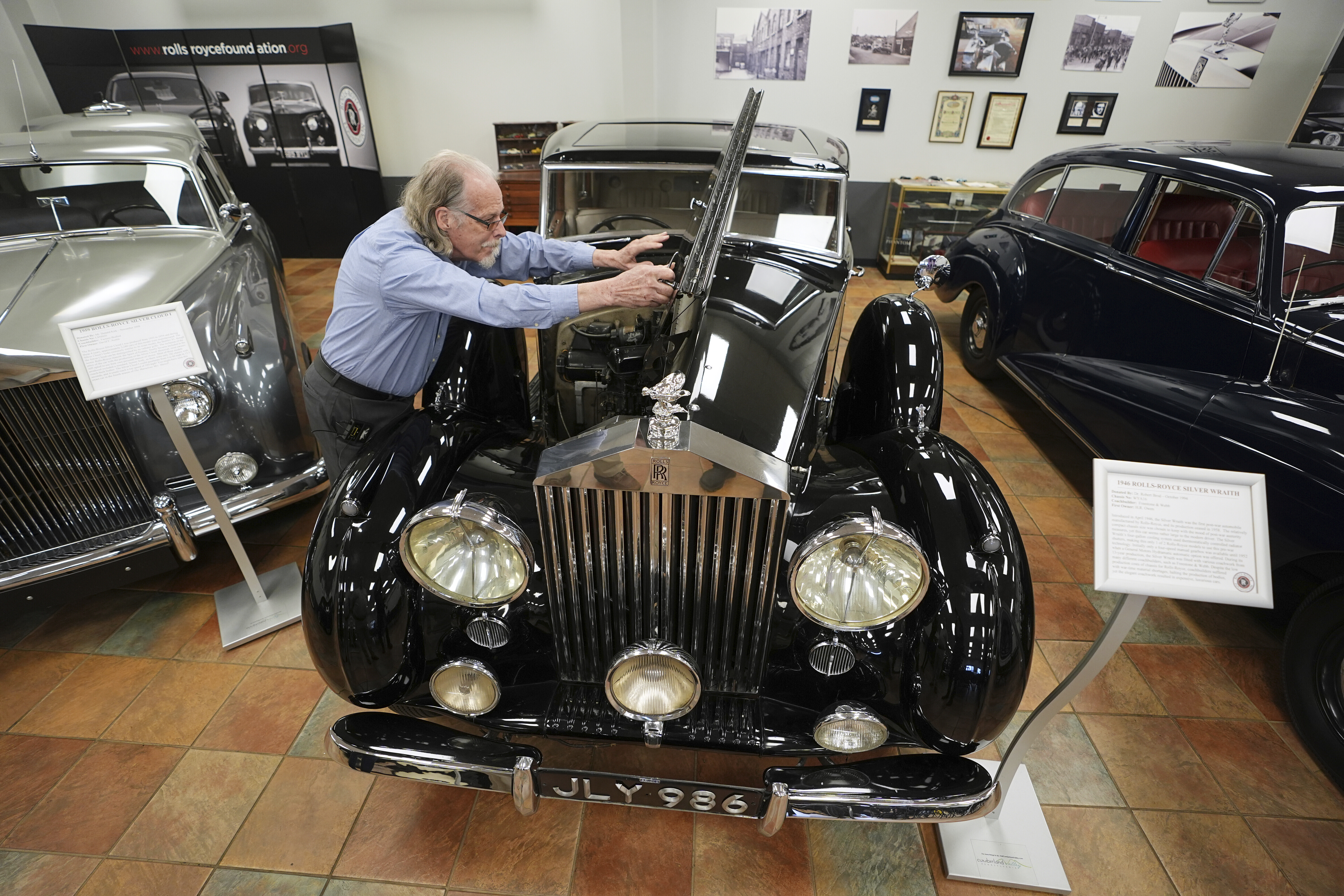 Tommy Tate opens the hood of a 1946 Rolls-Royce Silver Wraith during an interview at The Rolls-Royce Foundation in Mechanicsburg, Pa., Saturday, April 5, 2025.<br />(Matt Rourke / AP Photo)